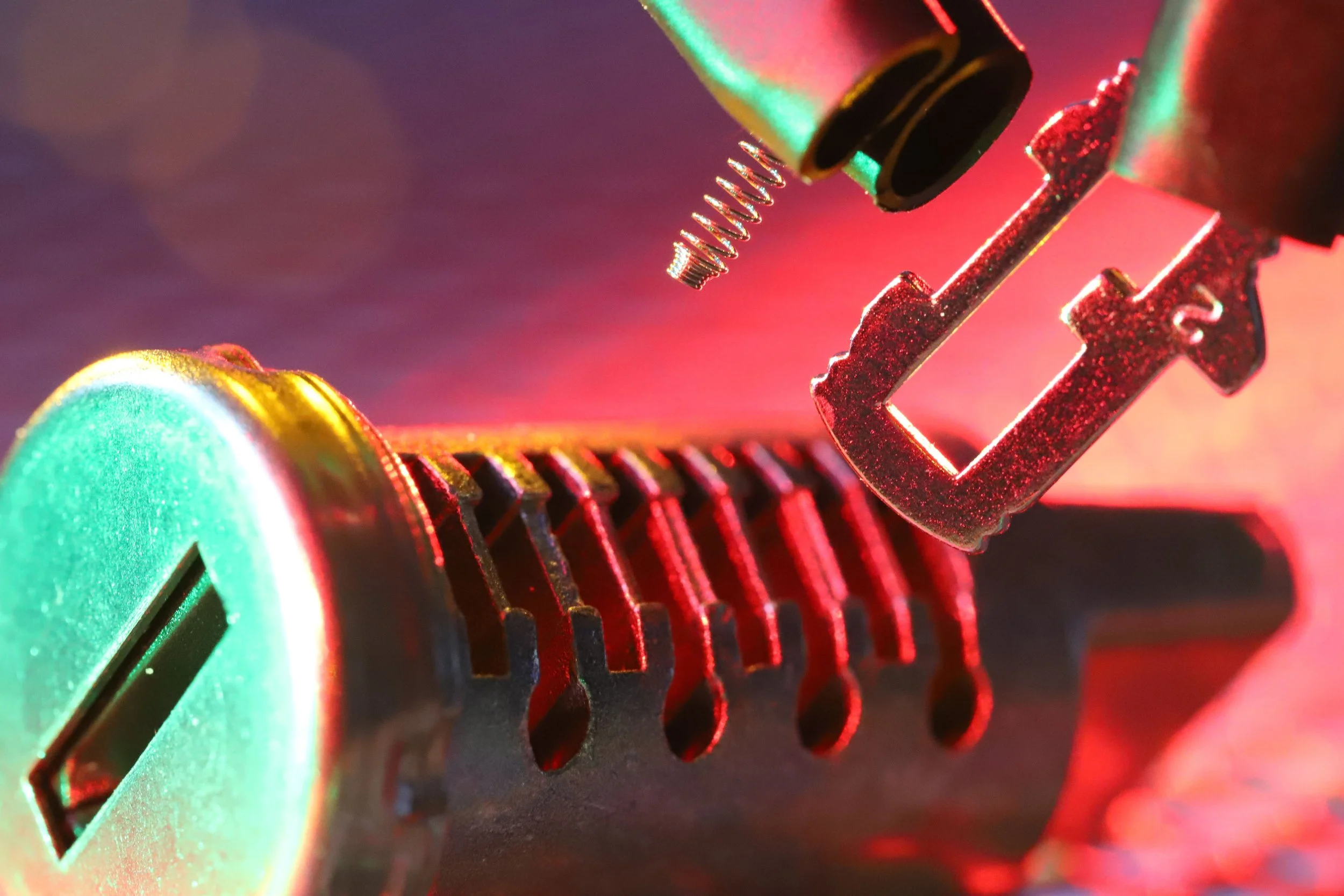Close-up of a computer graphics card with intricate metallic components, cooling fins, and colorful LED lighting.