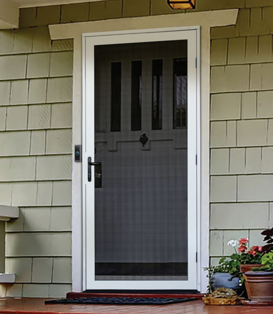 Screen door with a metal frame and mesh screen, leading to a house entrance with beige siding, a small porch, a potted plant with pink flowers, and a welcome mat.