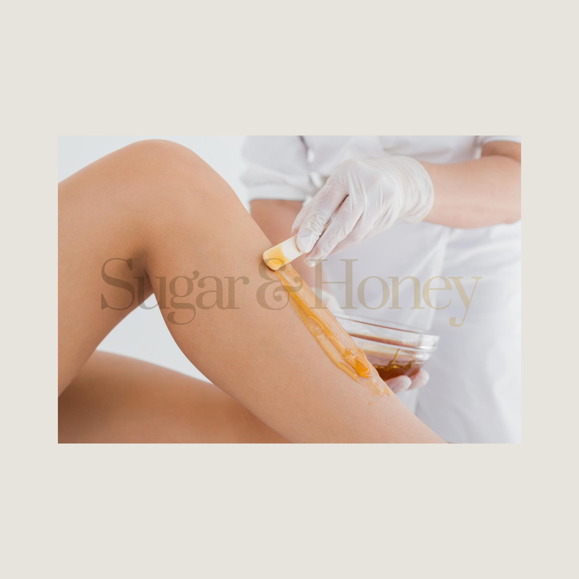 A person receiving a honey therapy treatment on their leg by a healthcare professional wearing gloves.
