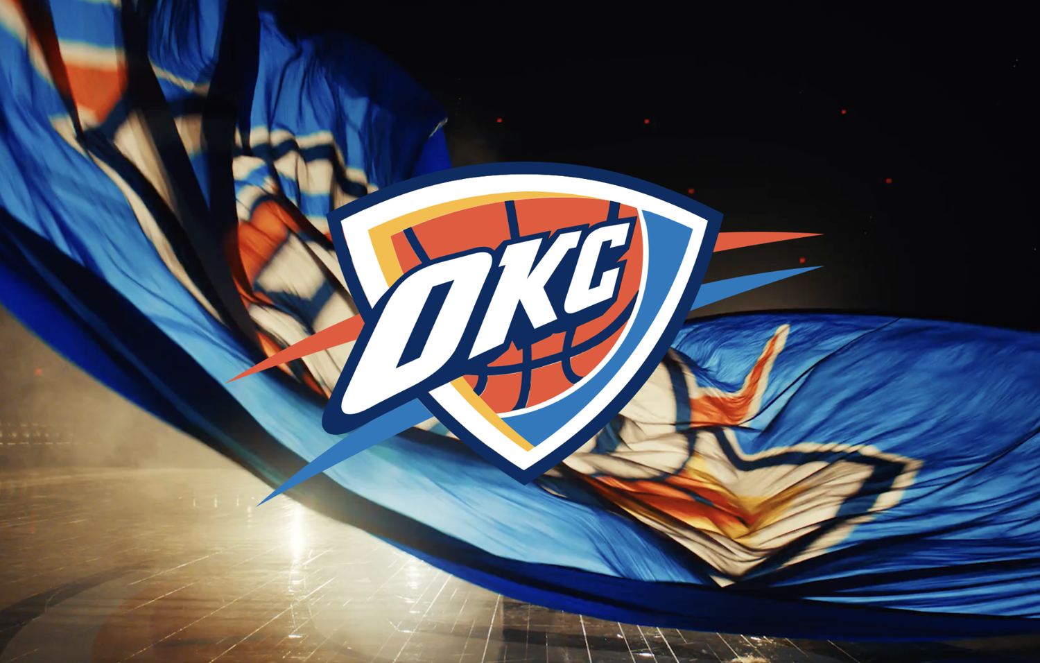 Oklahoma City Thunder logo superimposed over a flowing blue, white, and orange fabric with a black background.