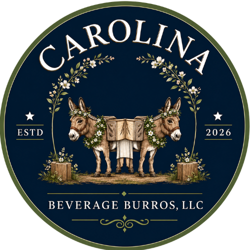 A circular logo for Beverage Burros, LLC, featuring two donkeys decorated with flowers and greenery, with the word 'Carolina' at the top, and 'ESTD 2026' on either side.