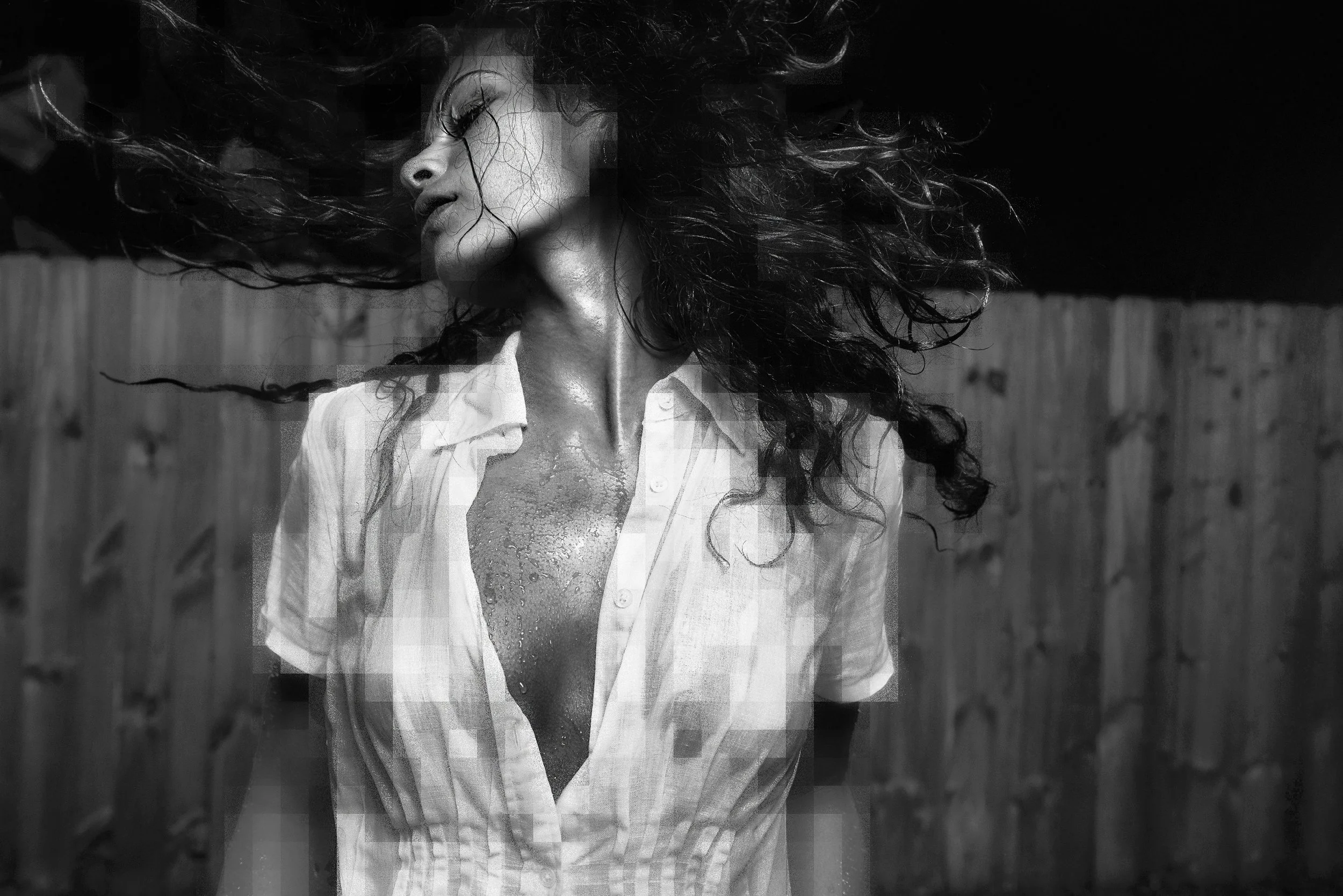 Black-and-white portrait with expressive movement and windblown hair. IZABELLA VILARCHAO