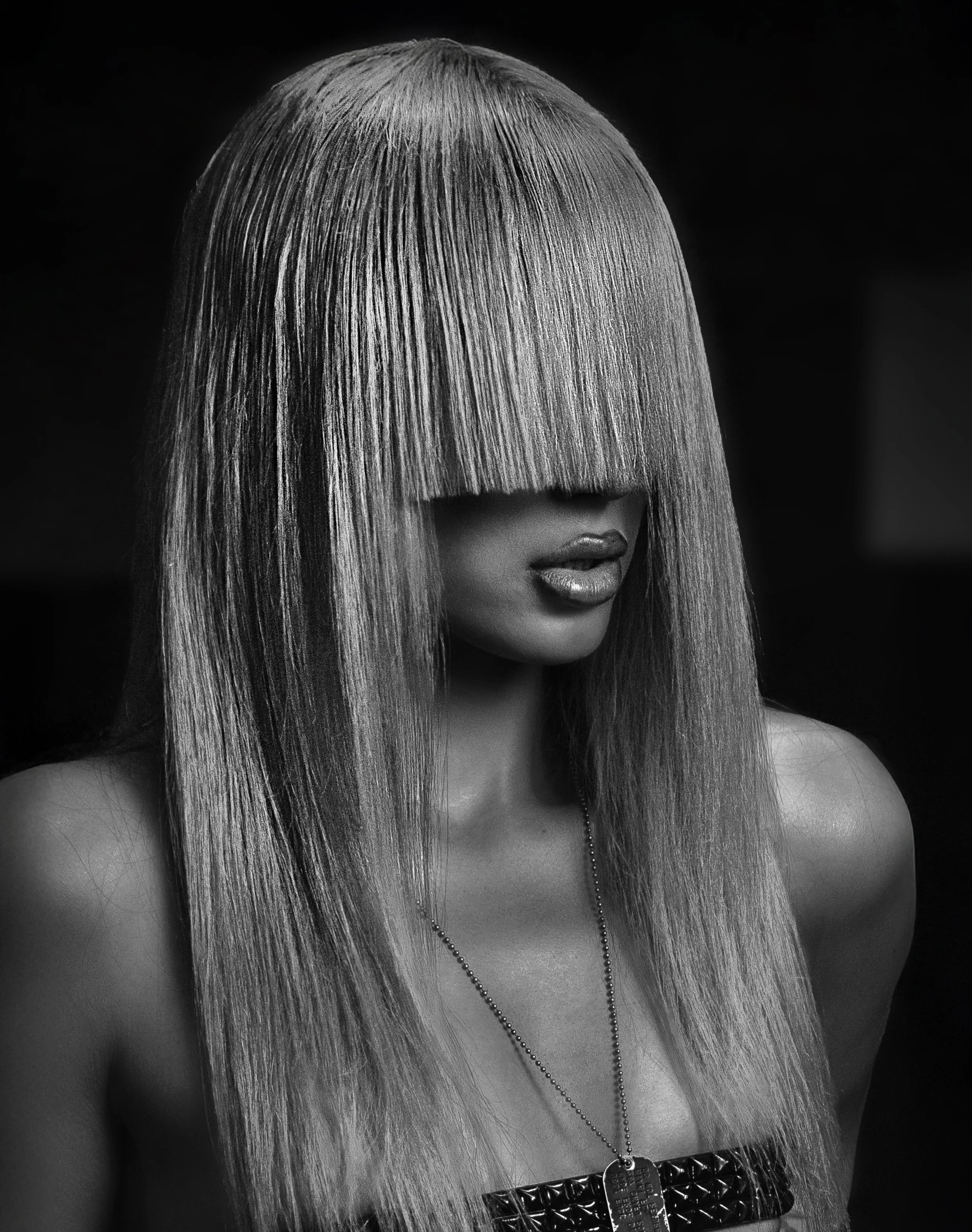 Black-and-white portrait with a metallic hair covering the face. TOMMY CARTER