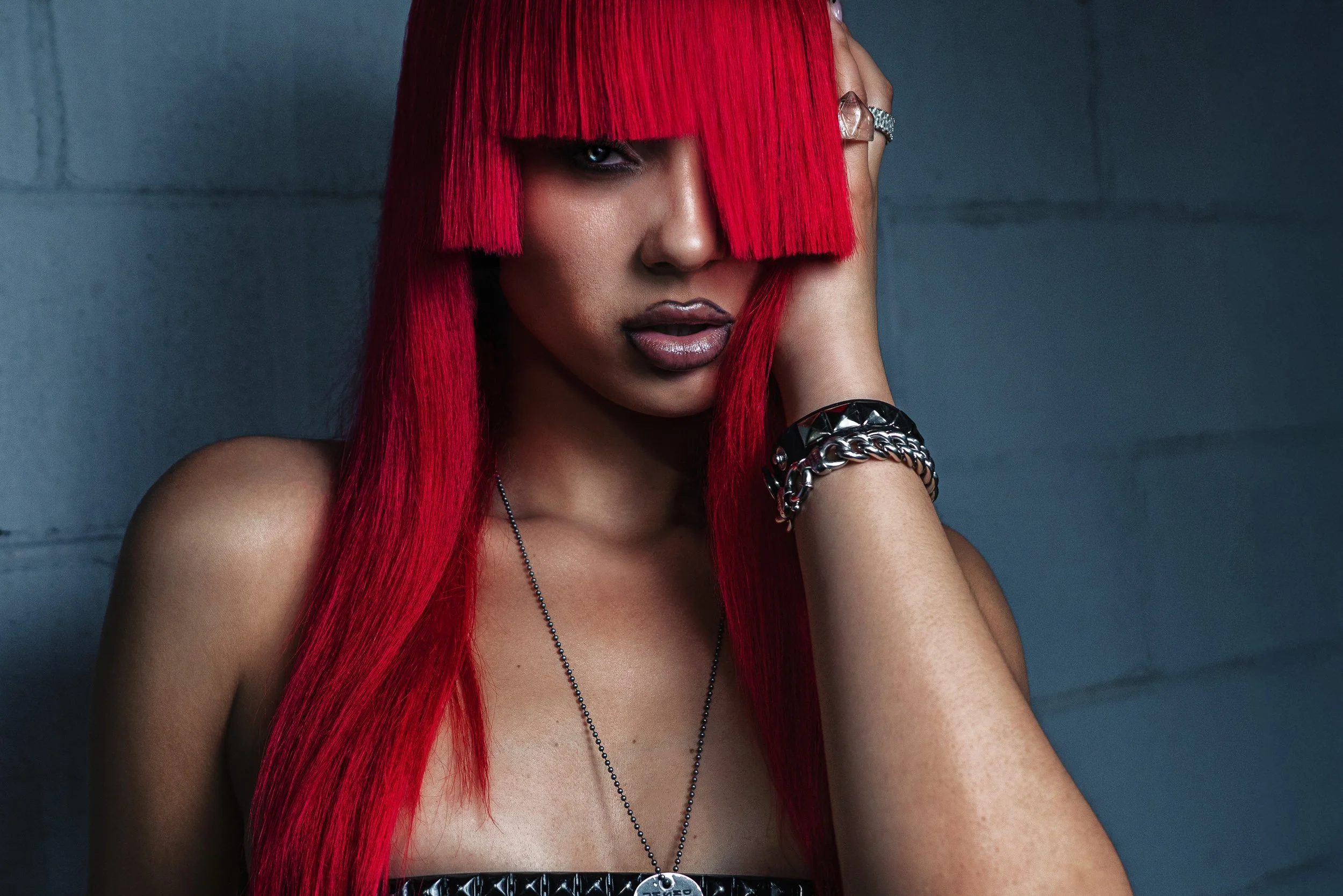 Fashion portrait with vivid red hair covering the face. TOMMY CARTER