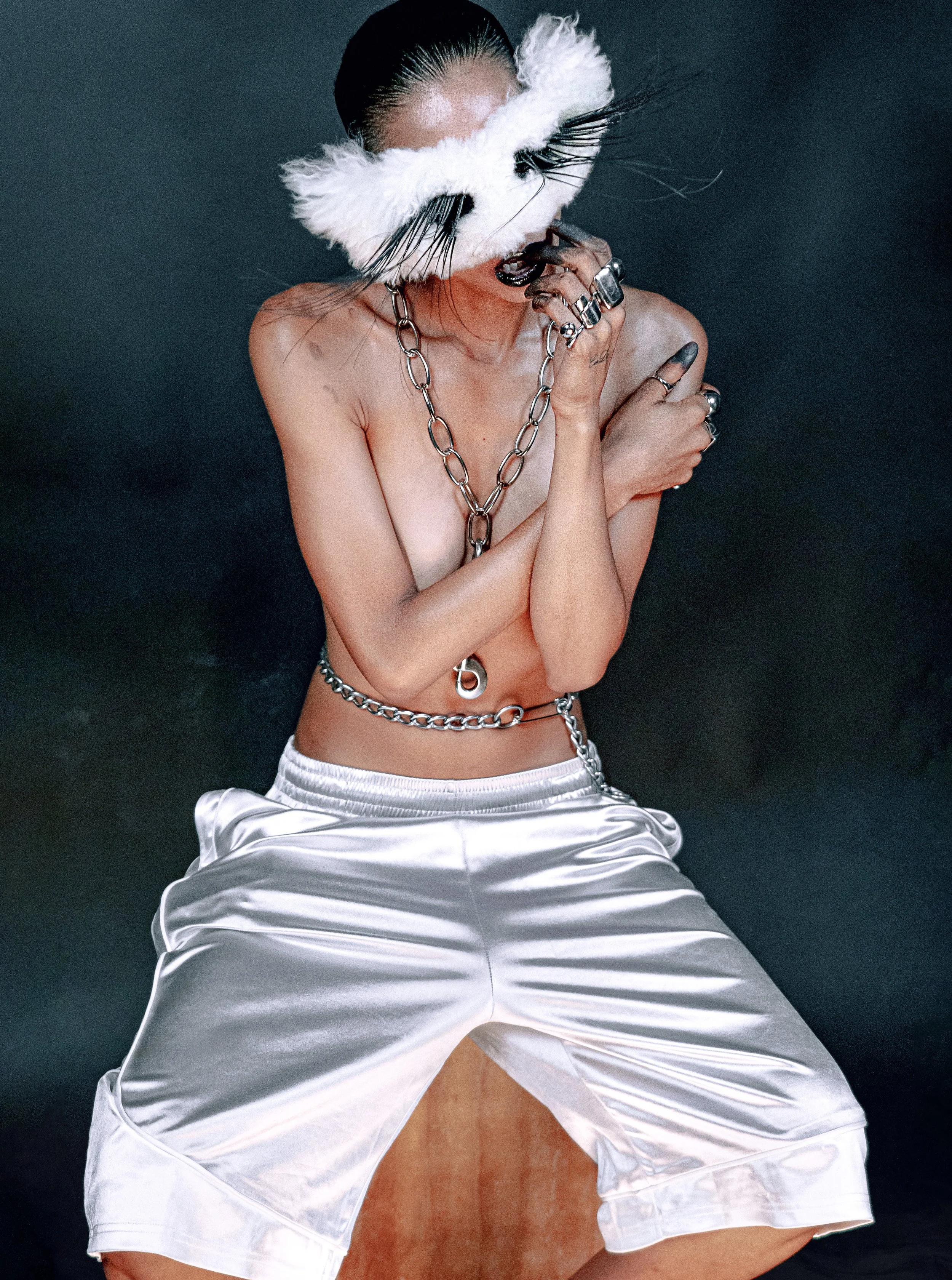 Fashion portrait of a shirtless female model wearing white pants. MARIAJOSE MARTE