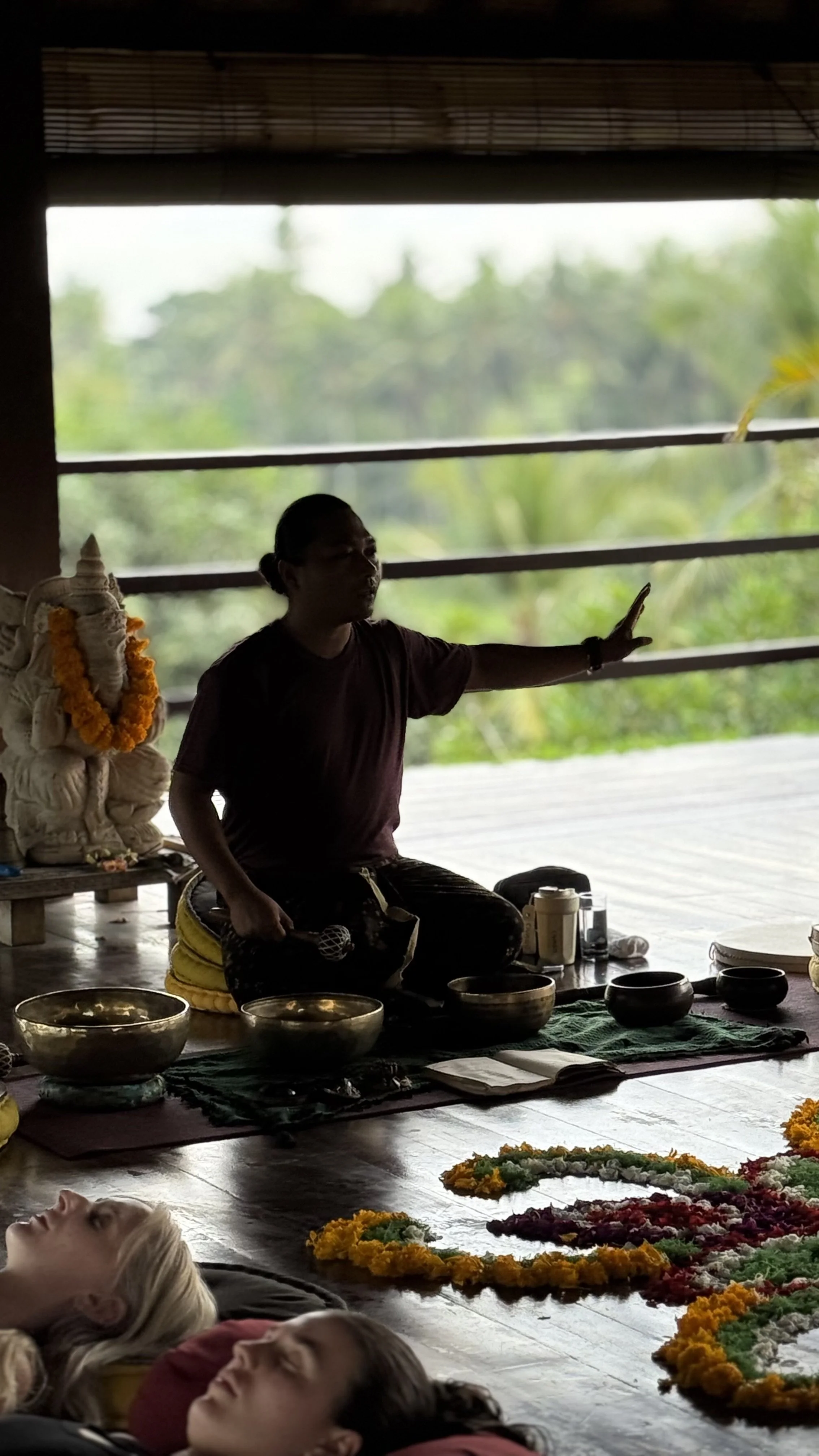 People laying down for a sound healing experience, while being guided.