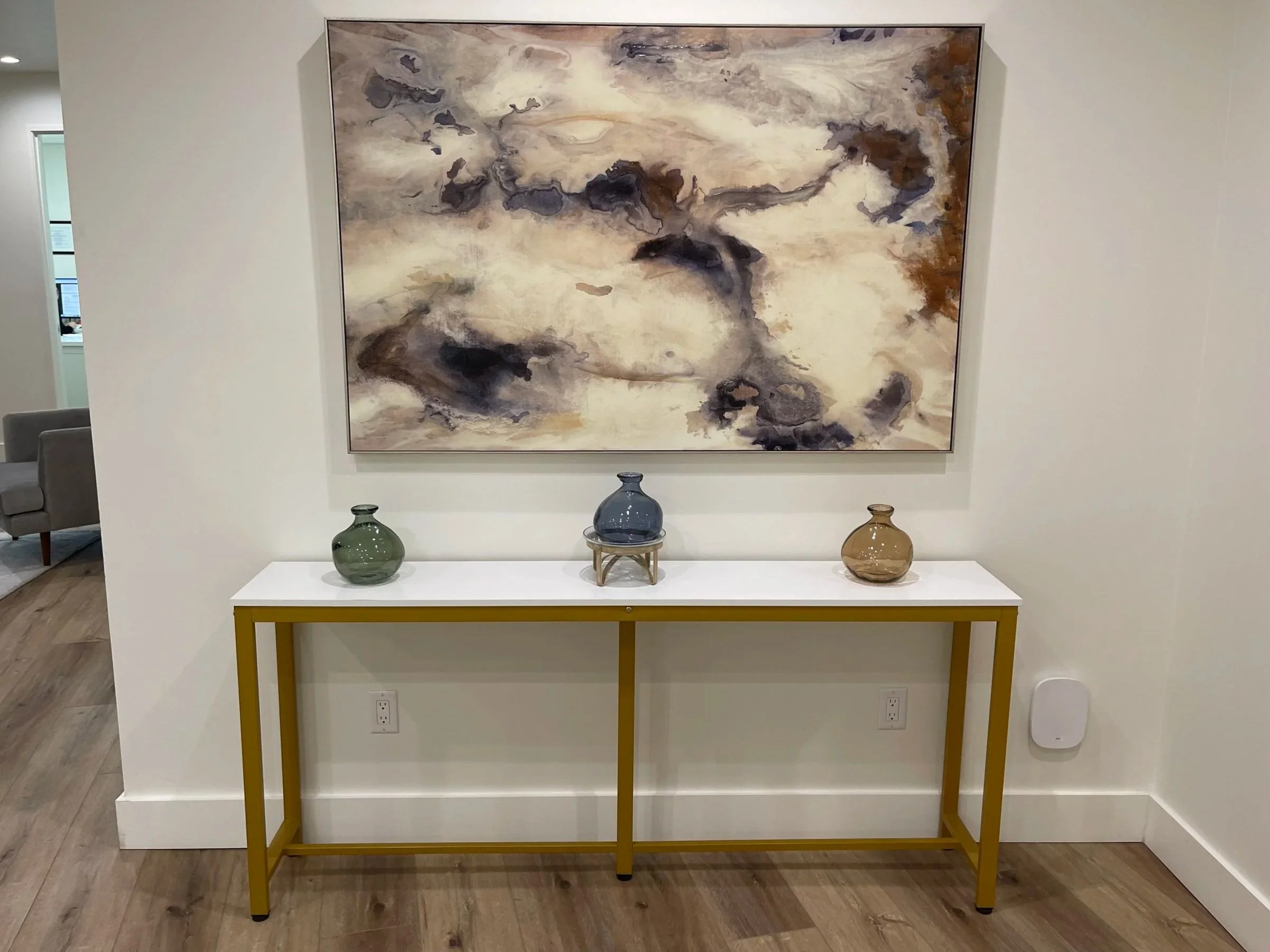 Welcoming entrance to Cheri Moi Skin Care in Westlake Village, featuring elegant décor, abstract artwork, and a beautifully styled console table. Cheri also welcomes clients at her Calabasas location.