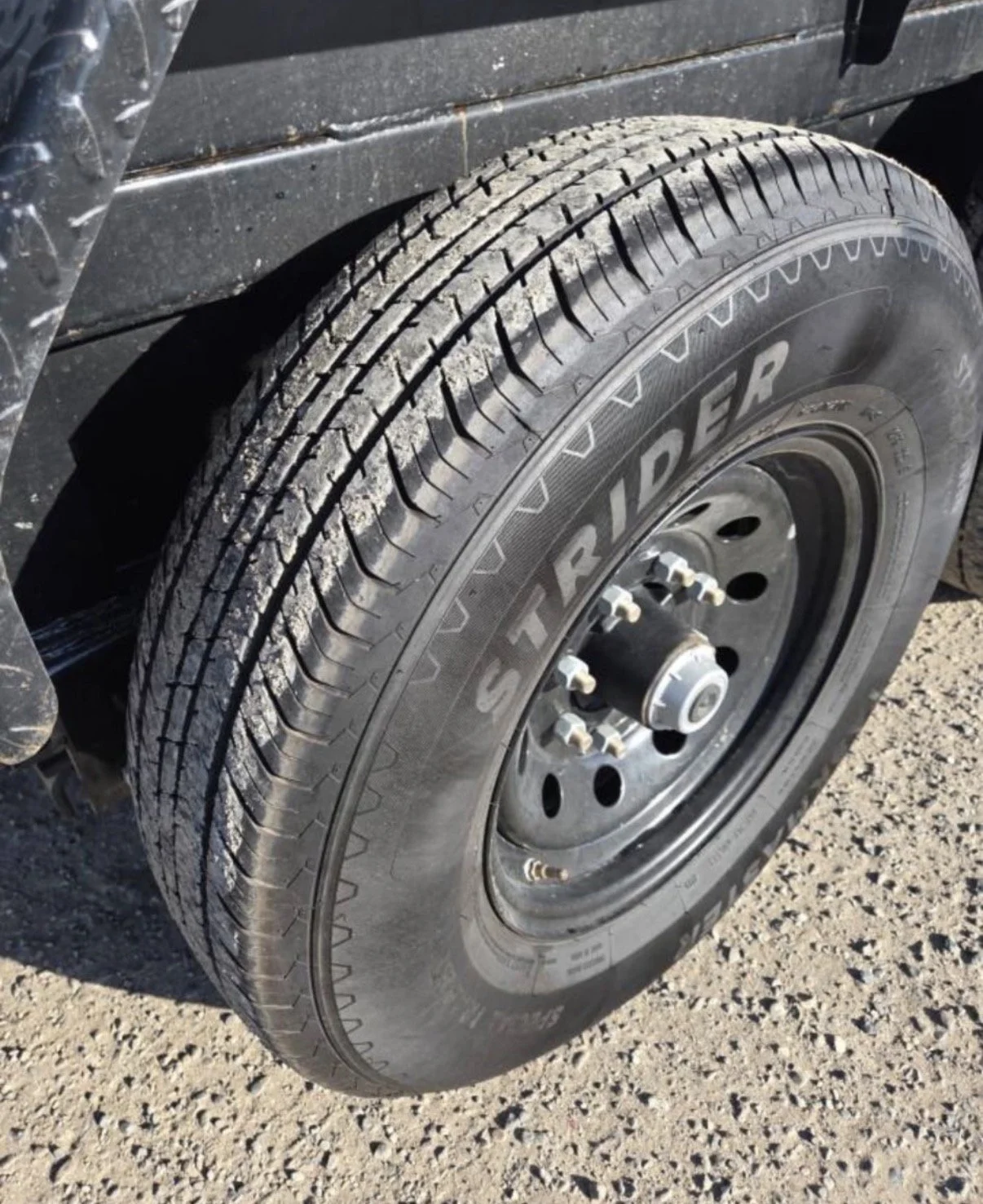 2026 ED dump trailer, close-up of tandem-axle tire and wheel.