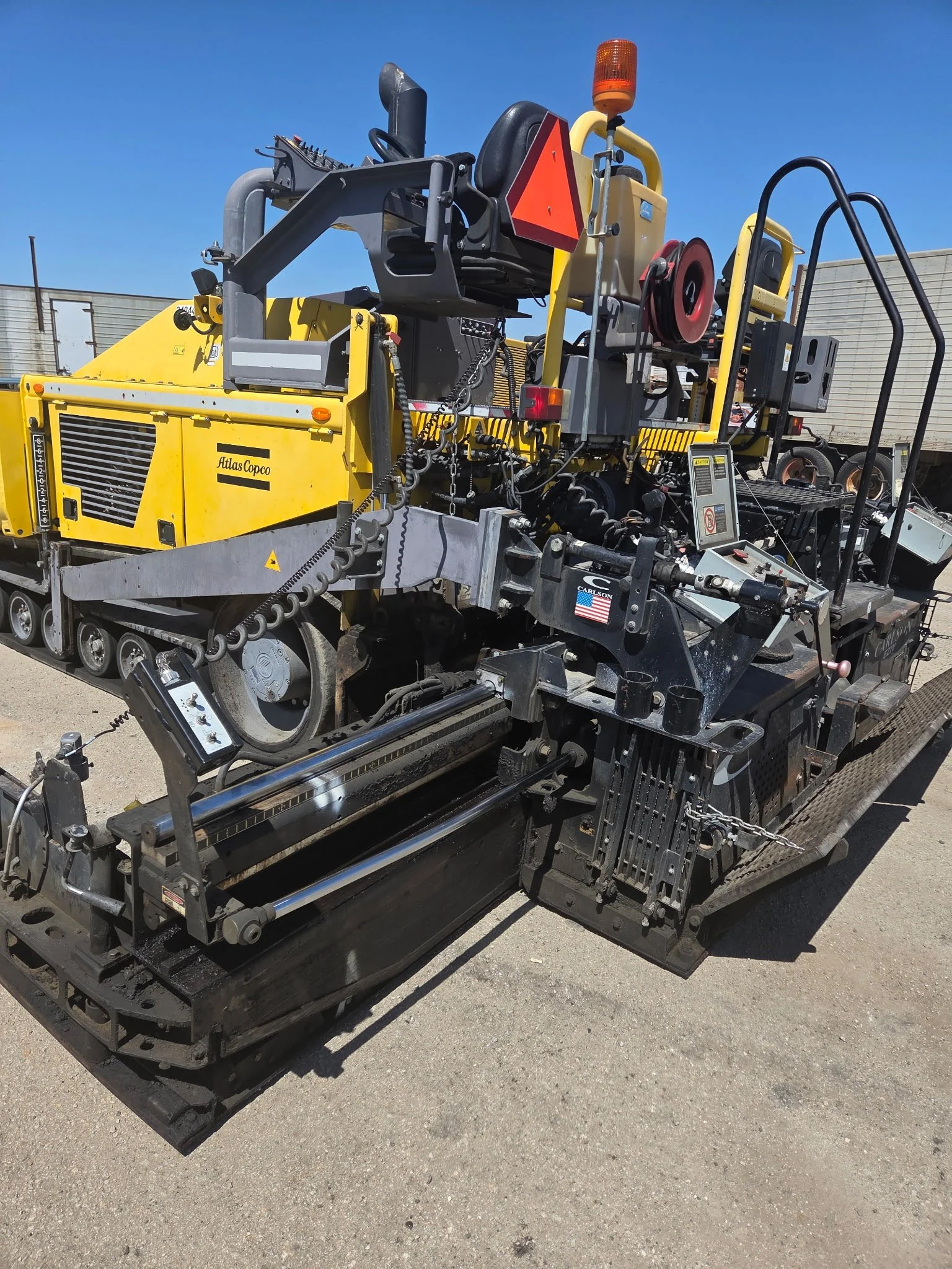 2017 Dynapac F1000T asphalt paver, close-up of hydraulic hoses and paving components.