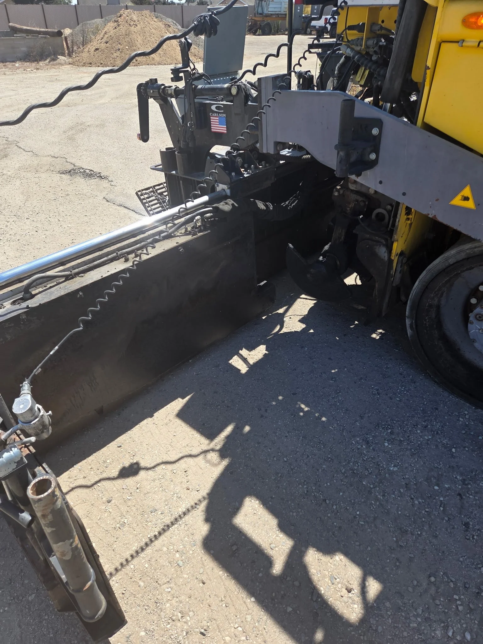 2017 Dynapac F1000T asphalt paver, close-up of paving screed and metal components.