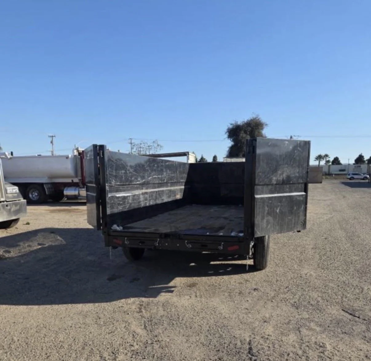 2026 ED dump trailer, front view showing black steel trailer body and frame.
