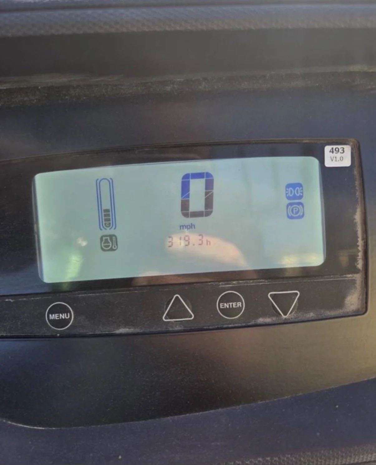 Digital dashboard display showing a speed of 0 mph, total hours of 319.3, and icons for battery, water, headlights, and parking brake.