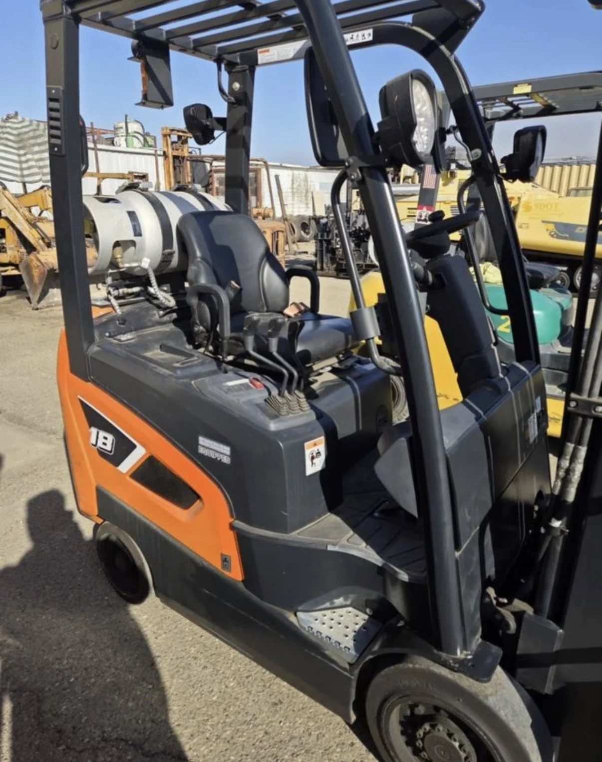 2021 Doosan GC18S-9 forklift, close-up of orange body panel with Doosan branding.
