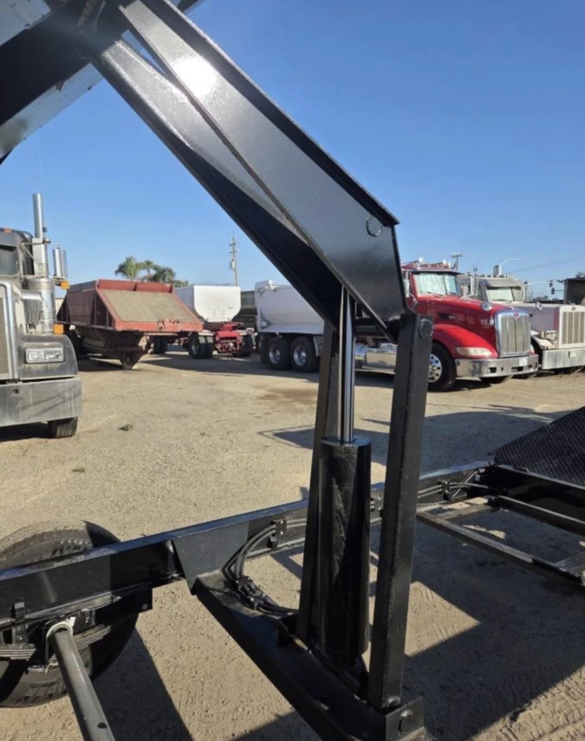 2026 ED dump trailer, hydraulic lift supporting the raised dump bed.