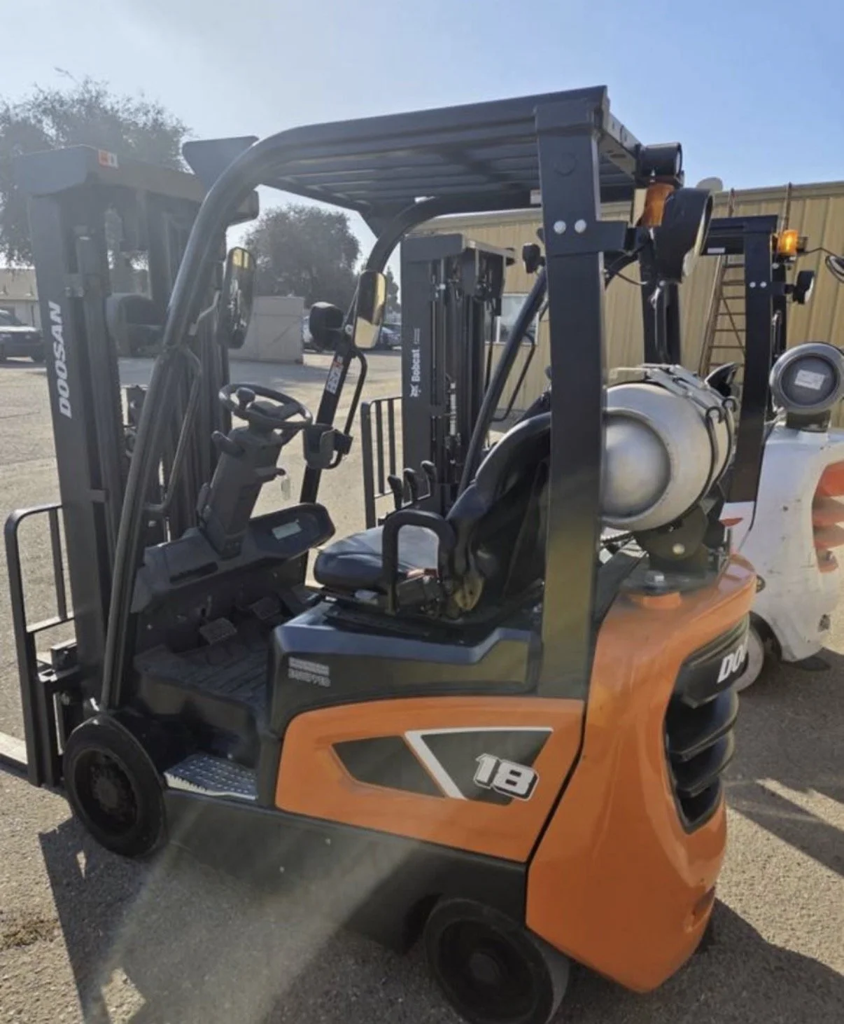 2021 Doosan GC18S-9 forklift, close-up of orange body panel and model markings.