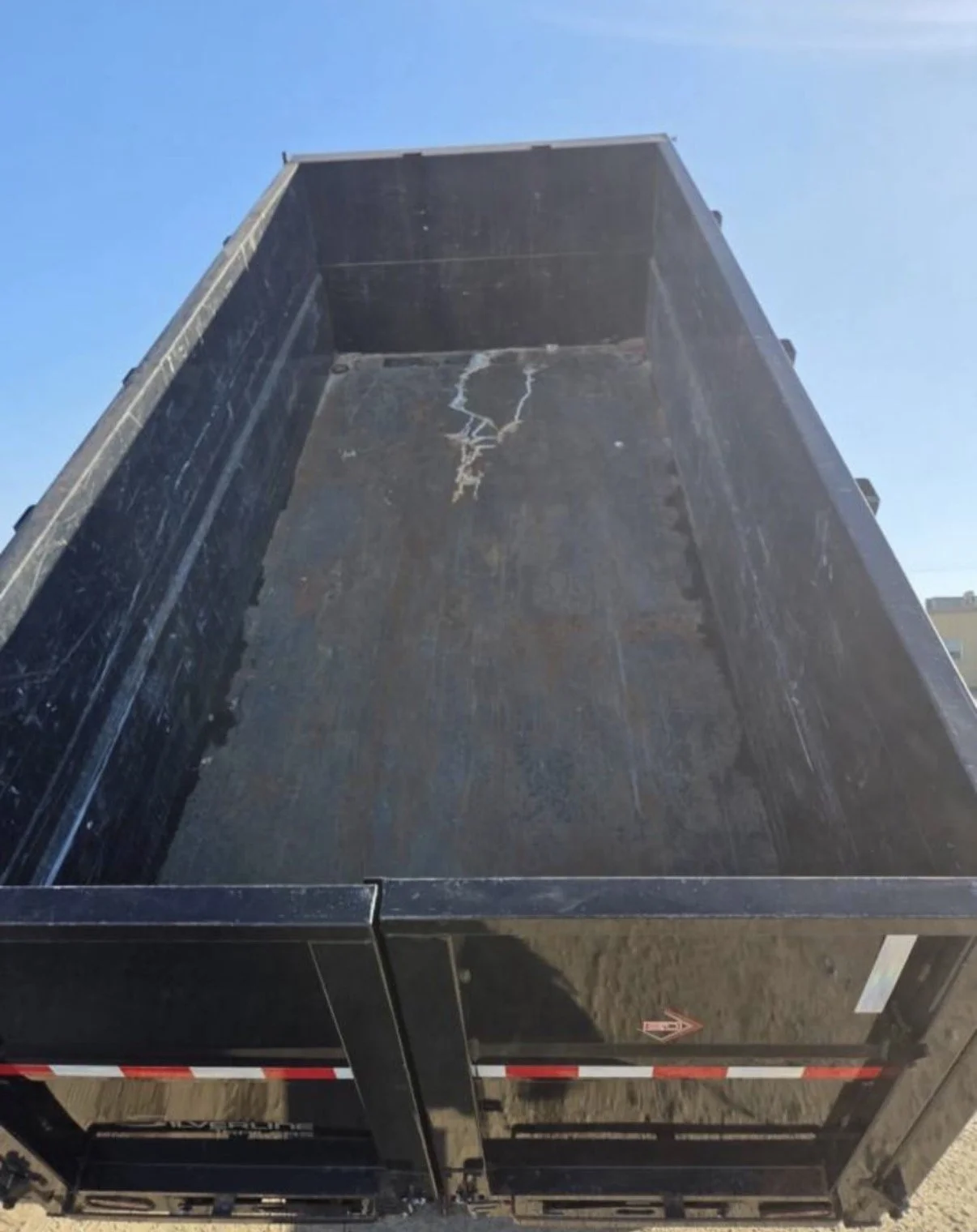 2026 ED dump trailer, view inside raised steel dump bed.