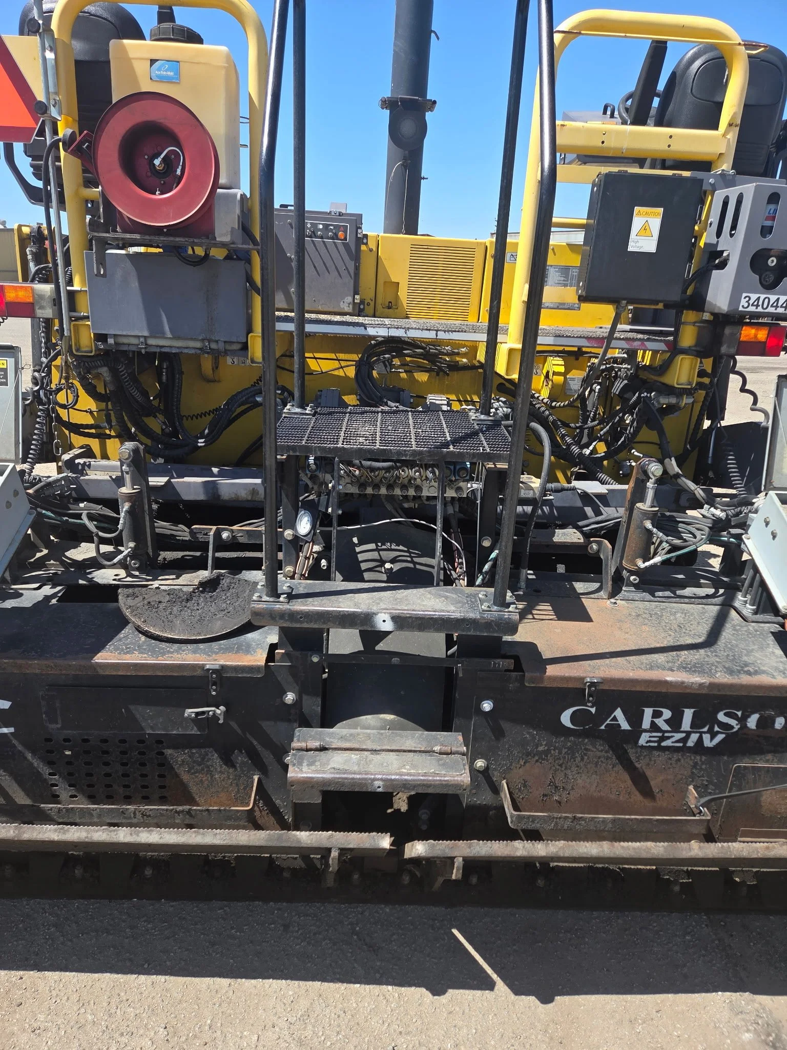 2017 Dynapac F1000T asphalt paver, close-up of paving machinery and hydraulic connections.