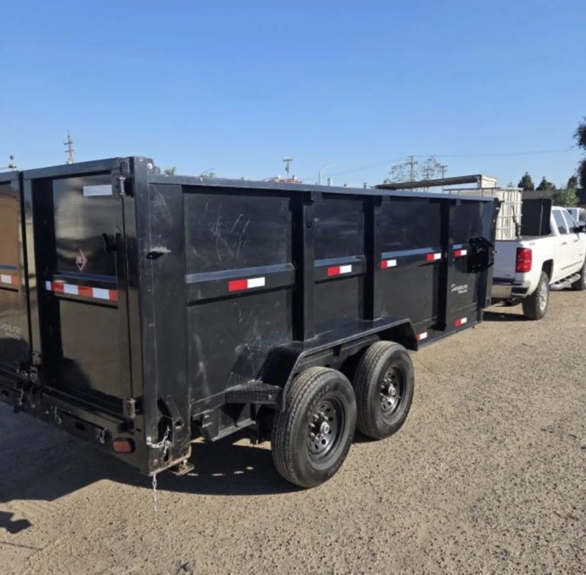 2026 ED dump trailer, black tandem-axle trailer shown from the side.