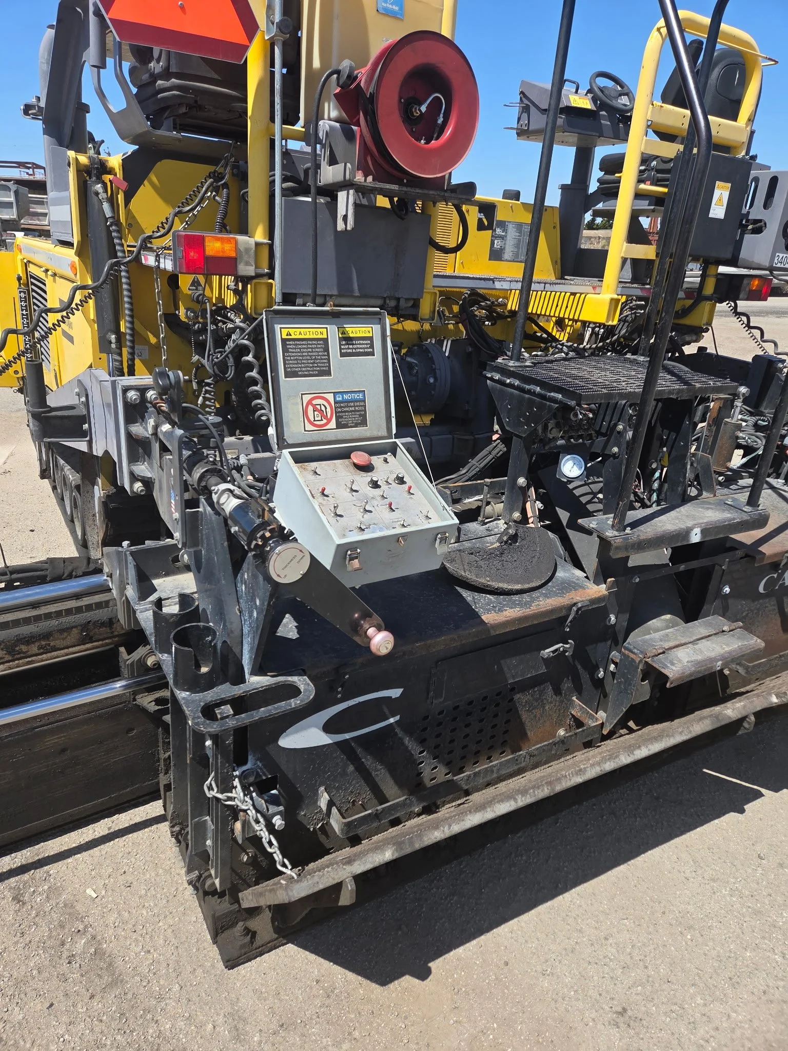 2017 Dynapac F1000T asphalt paver, close-up of paving machinery and hydraulic components.