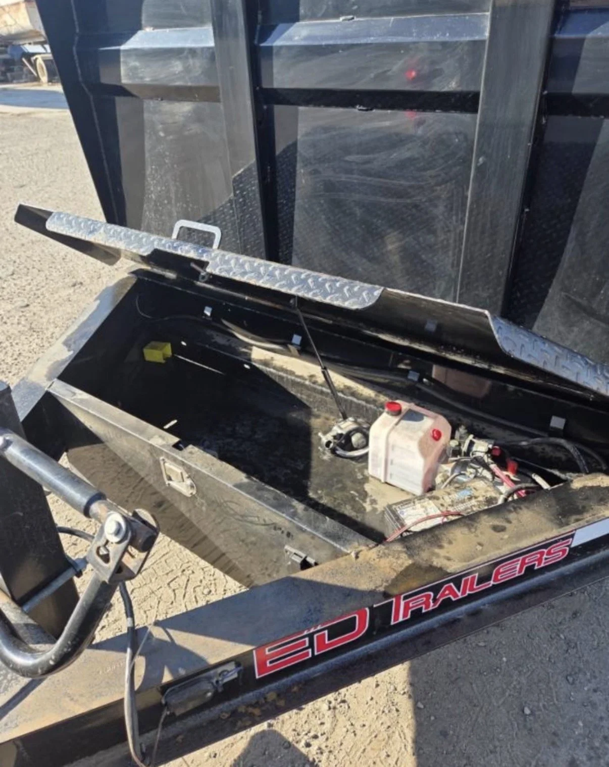 2026 ED dump trailer, close-up of hydraulic equipment and trailer components.