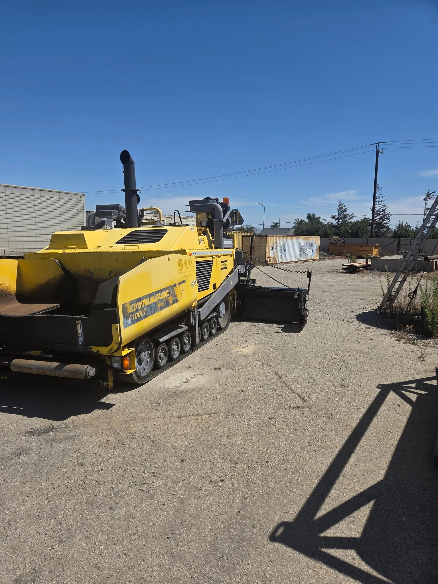 2017 Dynapac F1000T asphalt paver, side view showing yellow body and tracked undercarriage.