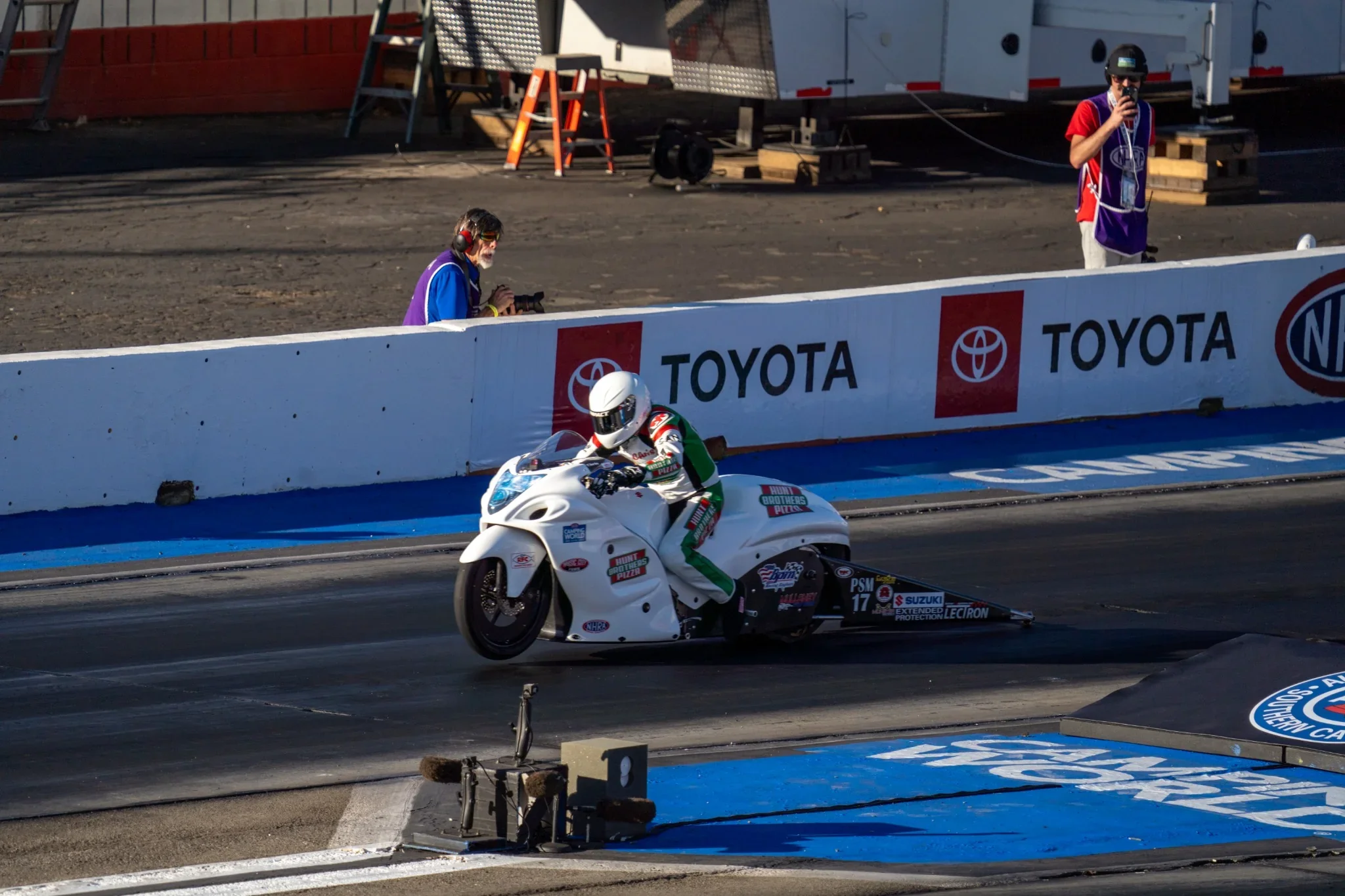 Motorcycle racer accelerating down a drag strip. Photograph by Christopher Behymer.