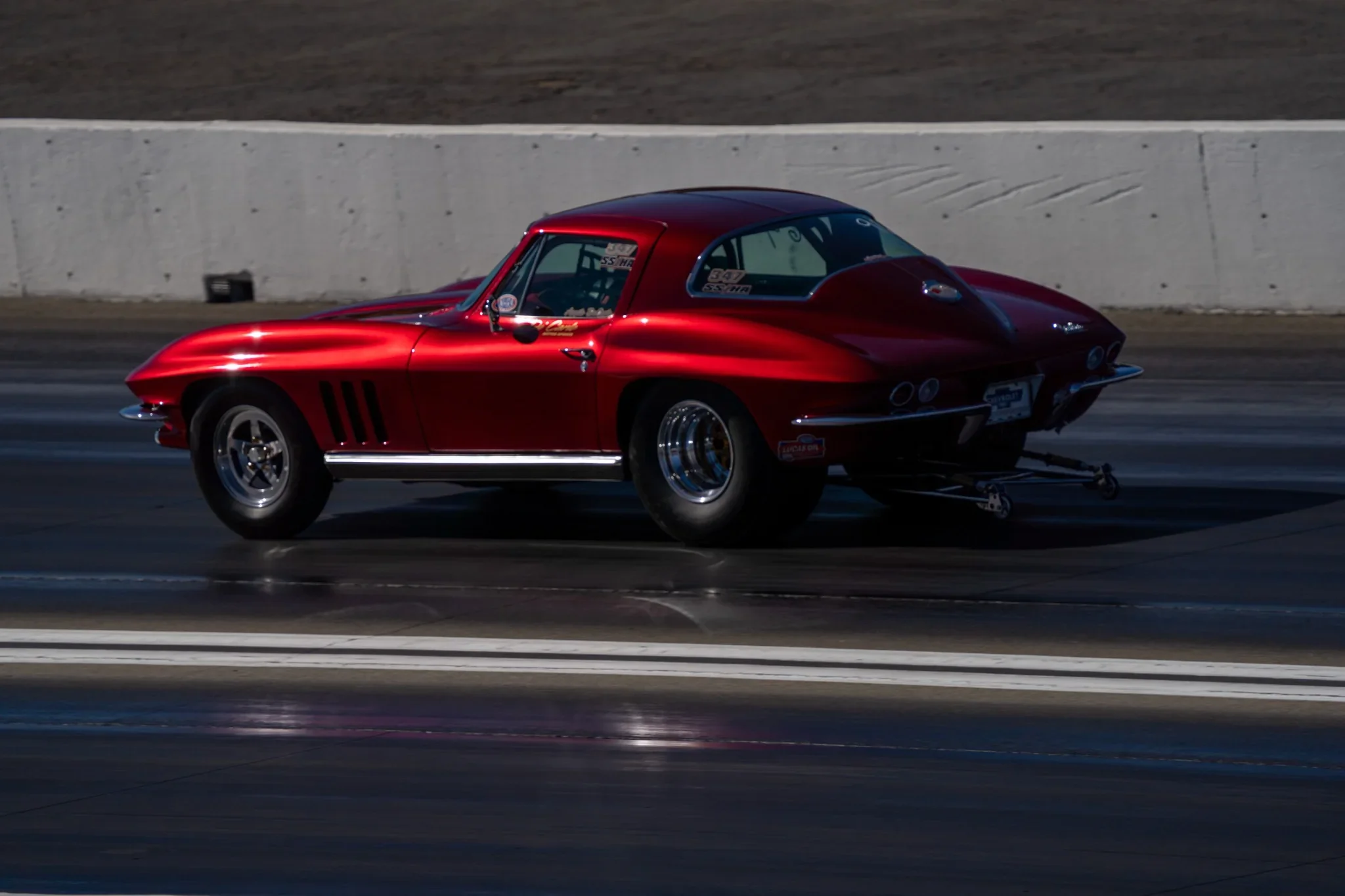 Red Corvette photographed in motion at a drag strip. Photograph by Christopher Behymer.