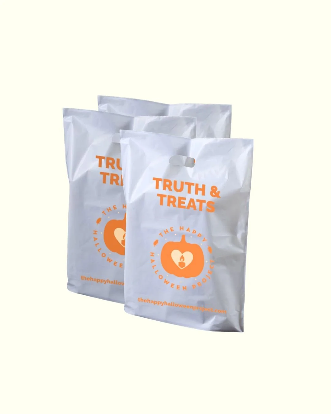 Three white plastic bags labeled 'Truth & Treats' with an orange pumpkin and candle graphic, on a plain white background.