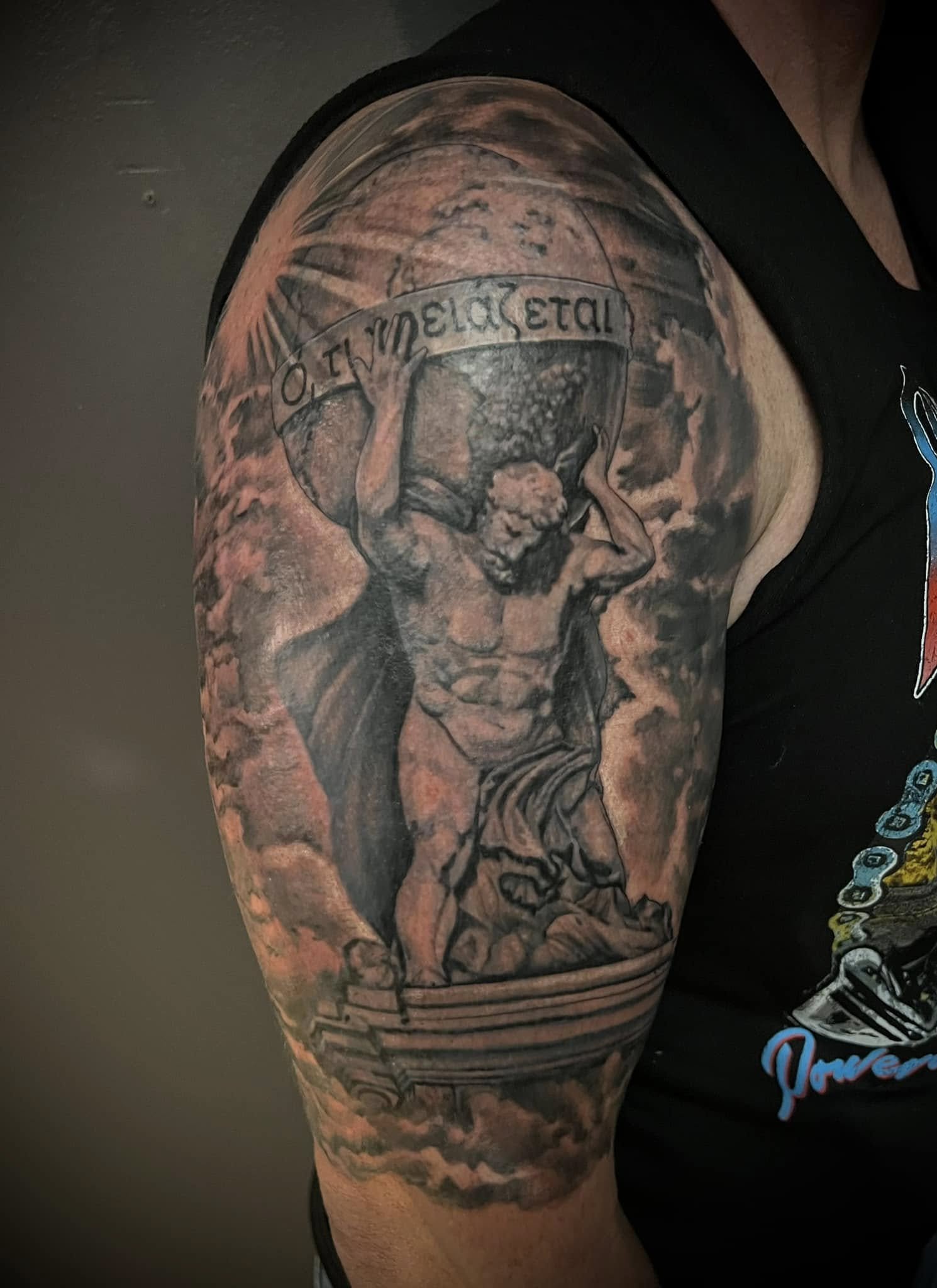 Black and gray detailed tattoo of a female figure with a banner around her head that says 'METAL'.
