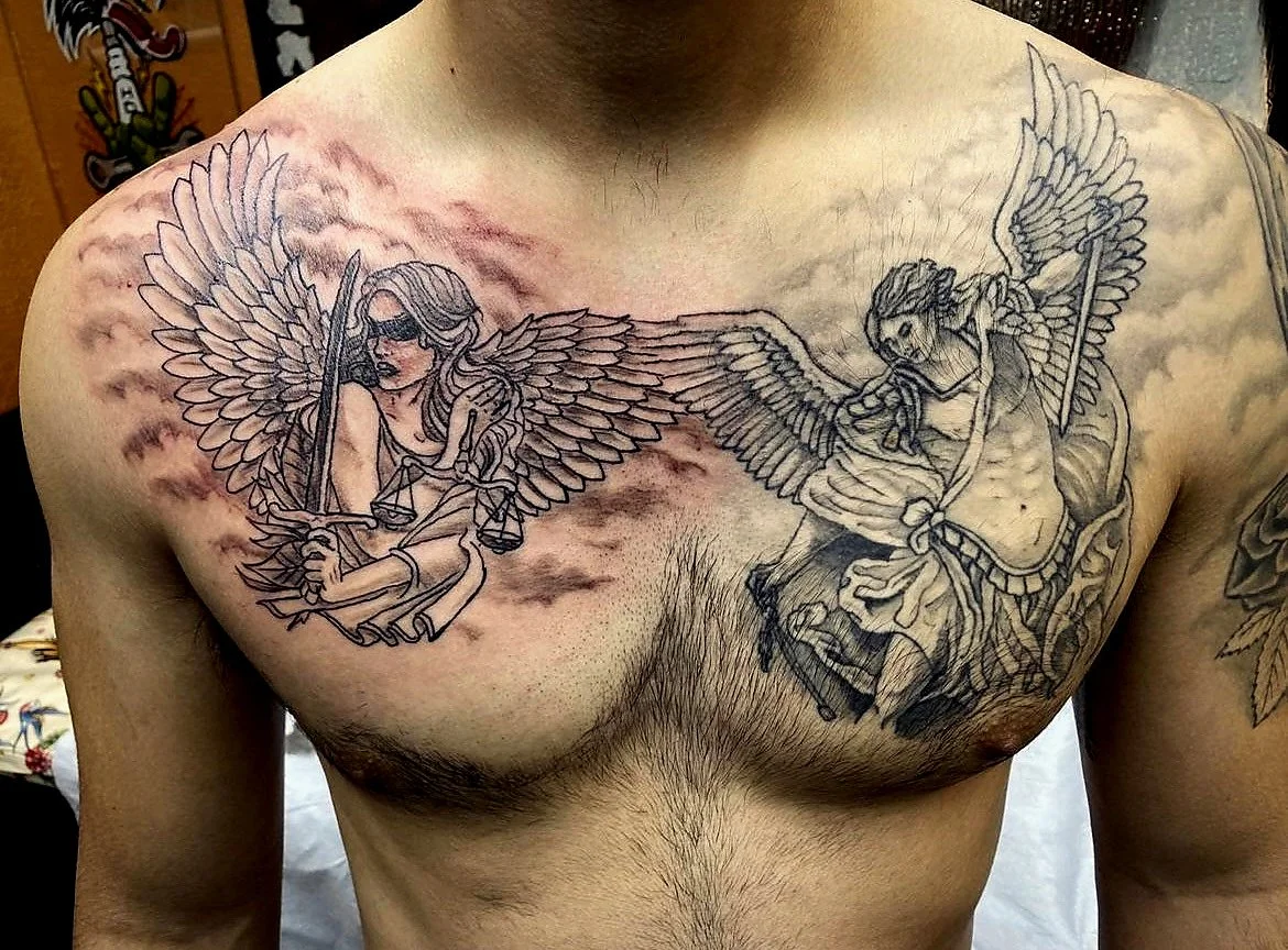 Tattoo of two winged characters on a person's chest, one with scales and blindfold holding a sword and scales, and the other with a spear, both surrounded by clouds.