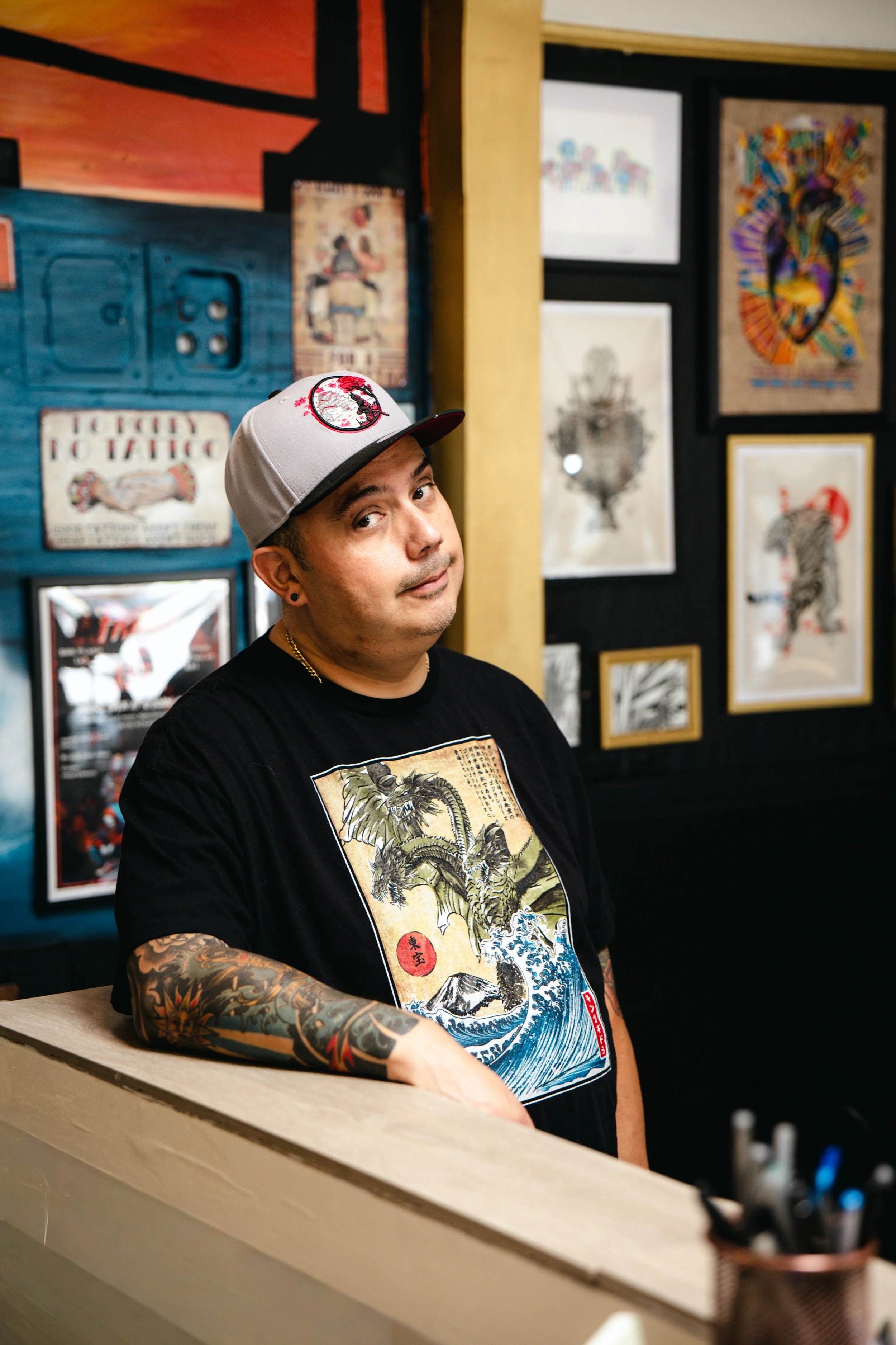 Tattoo artist creating a butterfly tattoo on a person's arm.