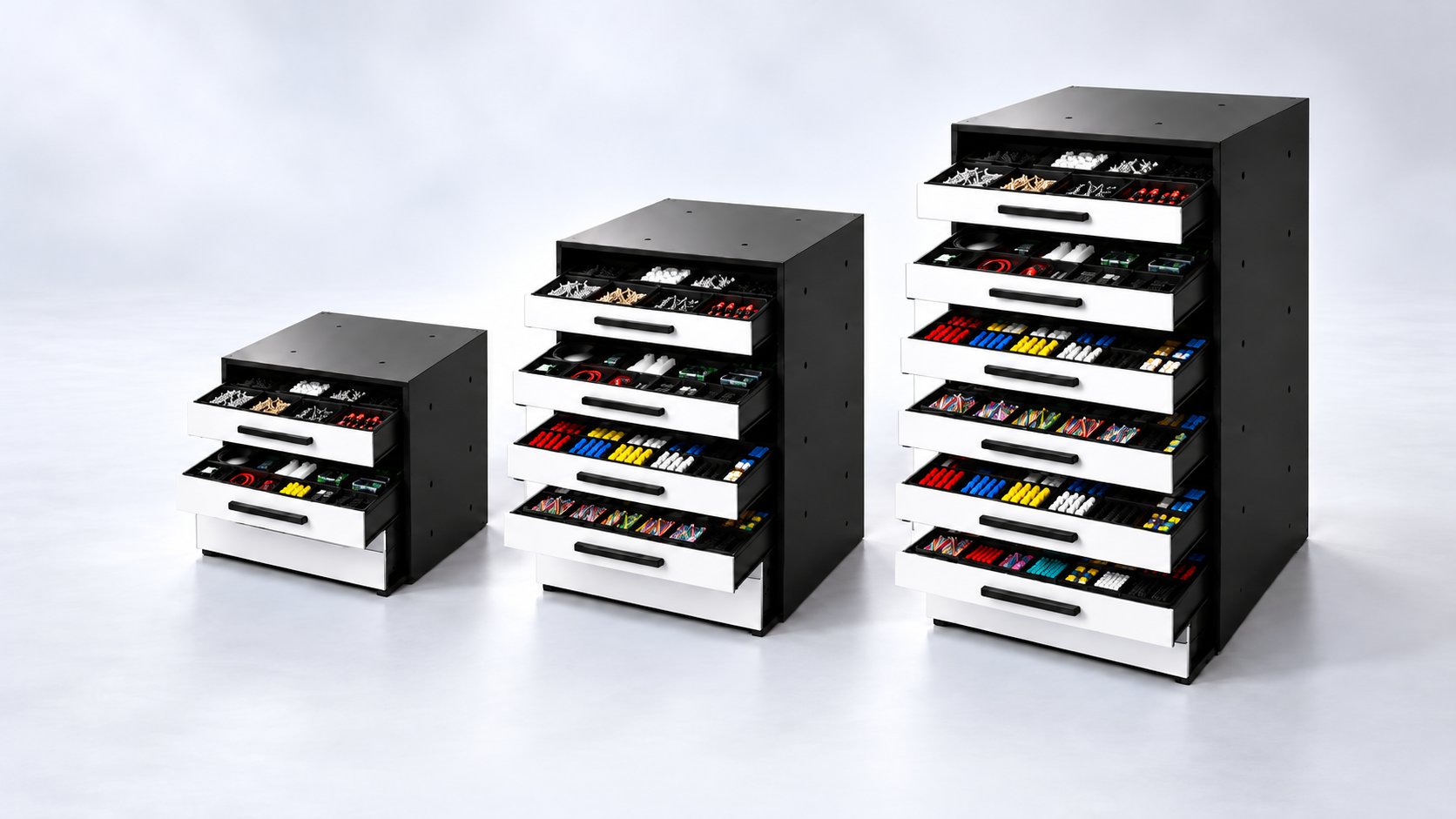 Three rolling storage carts filled with colorful supplies, organized in multiple drawers, on a plain white background.