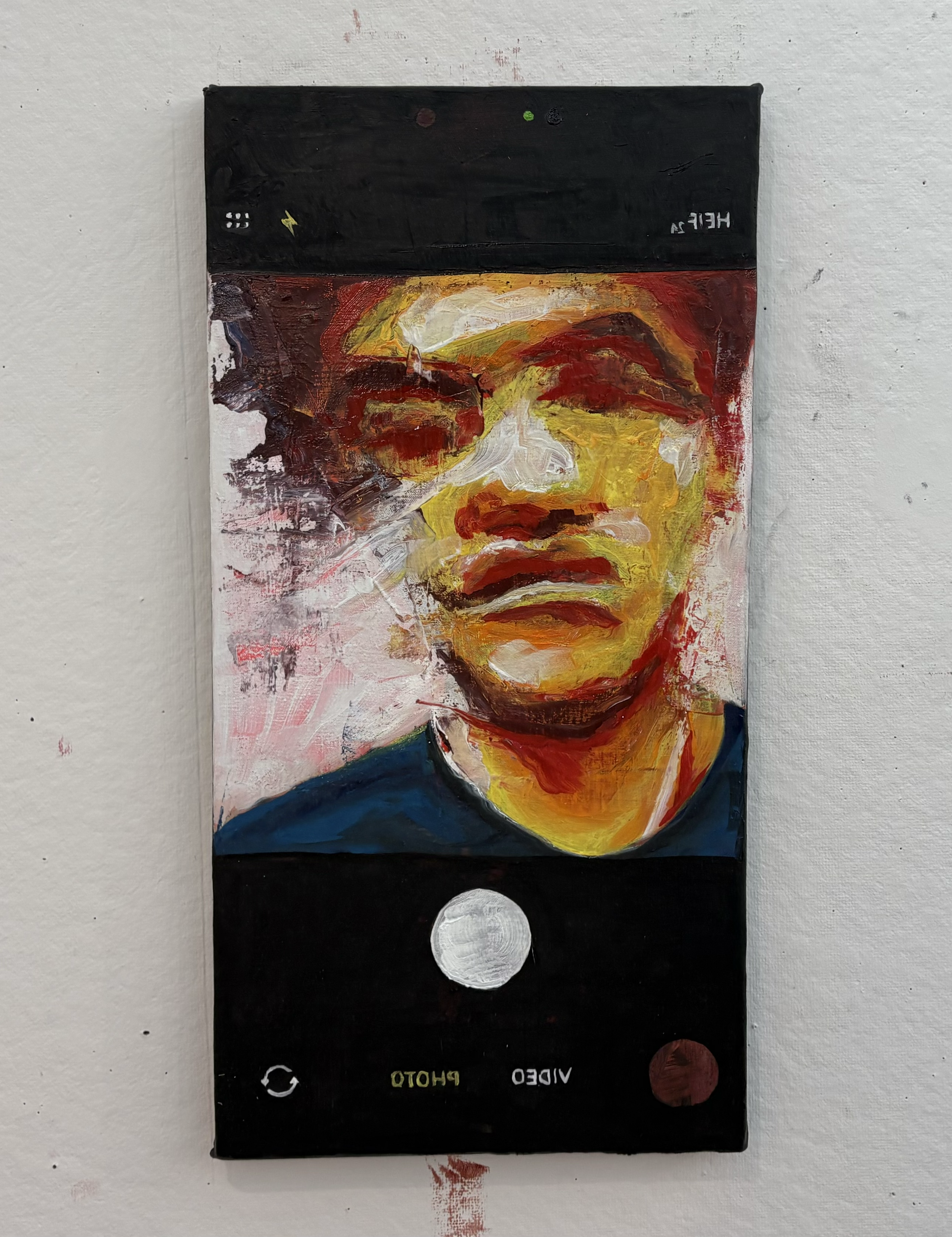 Abstract painting of a face with vibrant strokes and colors, including yellow, red, white, and dark blue, set against a mixed background with black and white sections, with reflective text and symbols.