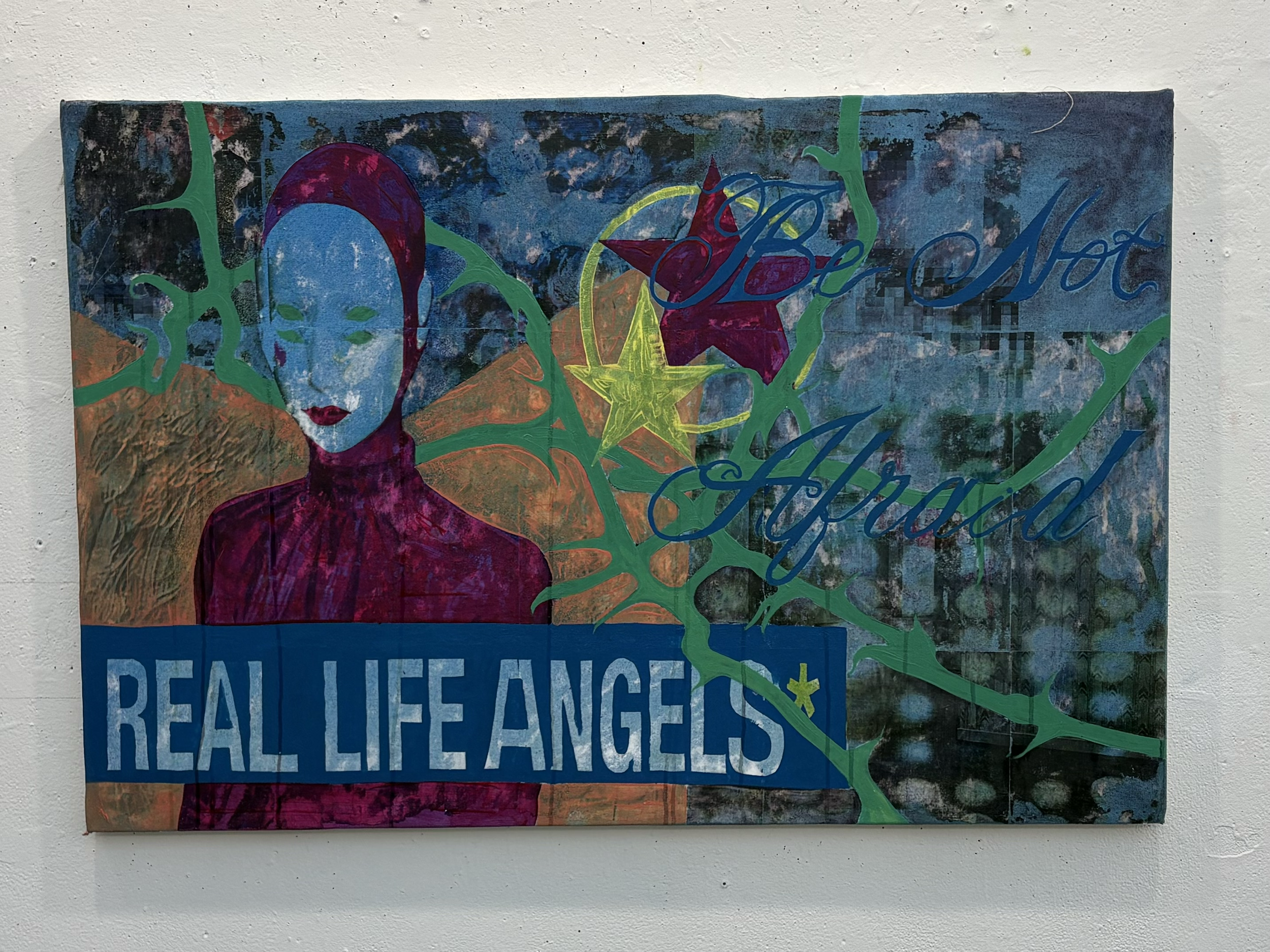 A colorful mixed media artwork with a blue background, featuring a stylized portrait of a woman with purple hair, red lips, surrounded by green abstract shapes, a yellow star, and the words 'Be Not' written in blue cursive. The lower part includes a 