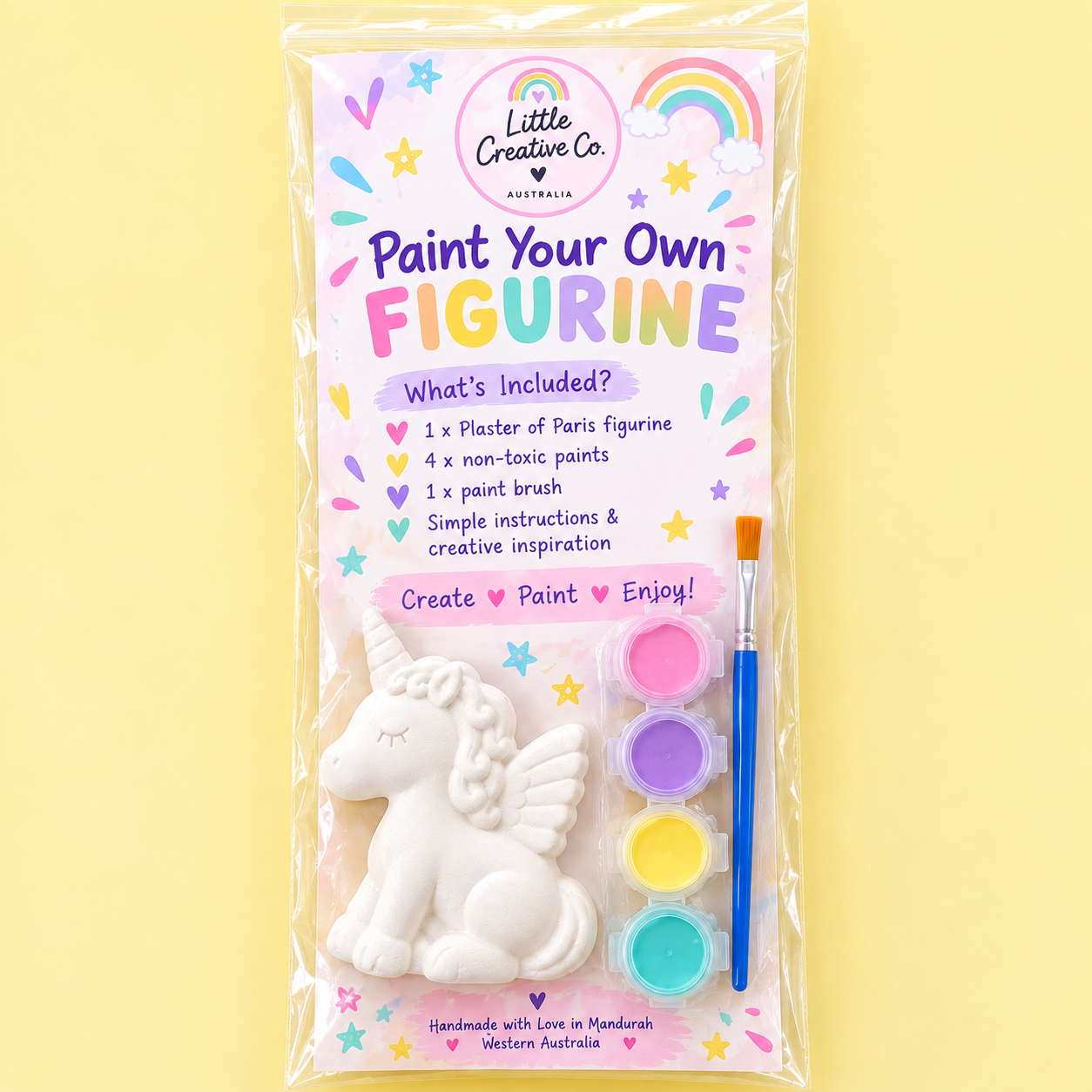 A unicorn-shaped plaster and paint kit with four non-toxic paints and a paintbrush, packaged in a clear plastic bag on a yellow background.