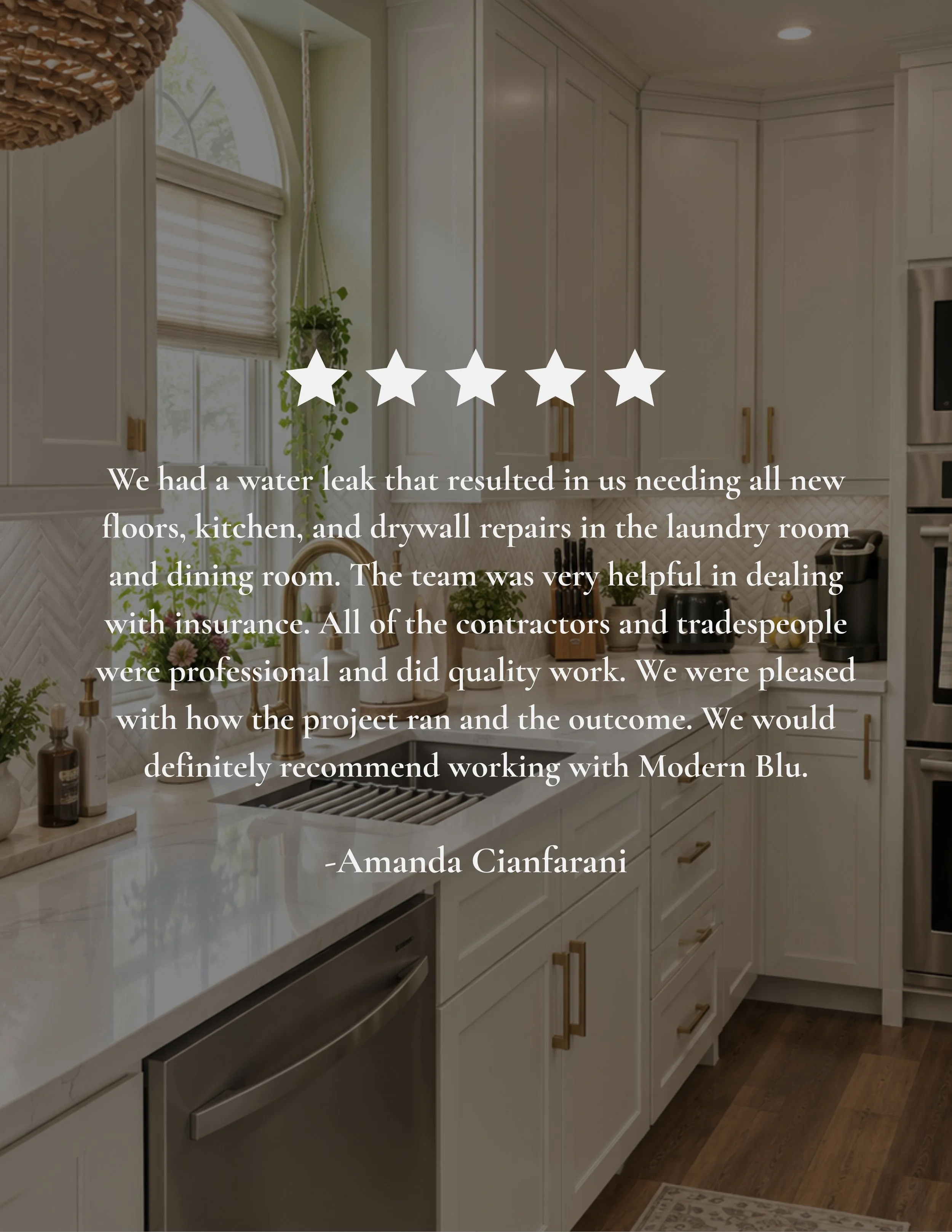 Kitchen with white cabinets, a window with a blind, a hanging plant, and a marble countertop with kitchen utensils and appliances.