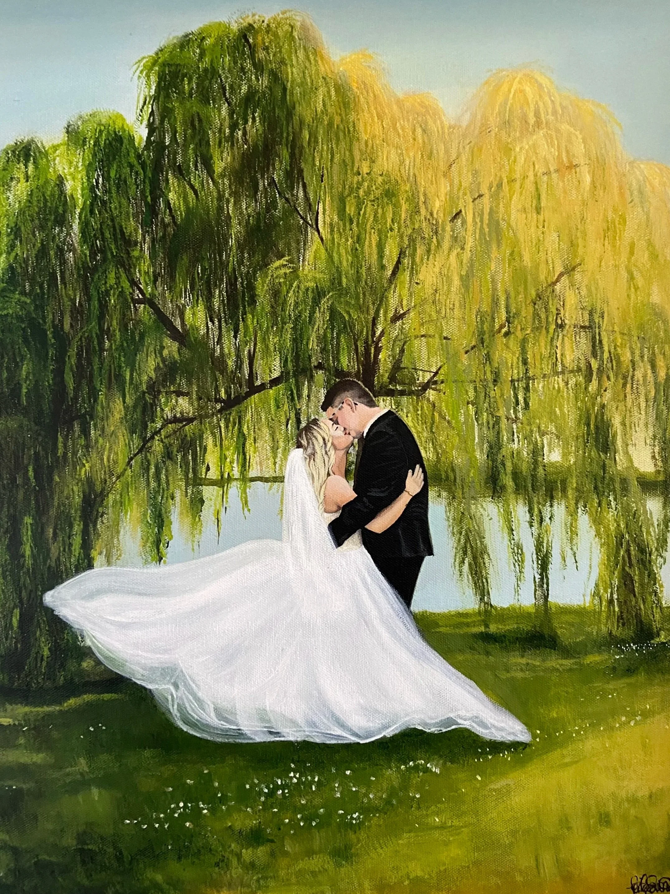 A bride and groom sharing a kiss under large, overhanging trees with drooping branches and yellowish-green leaves. The bride is in a white wedding dress, and the groom is in a black suit.