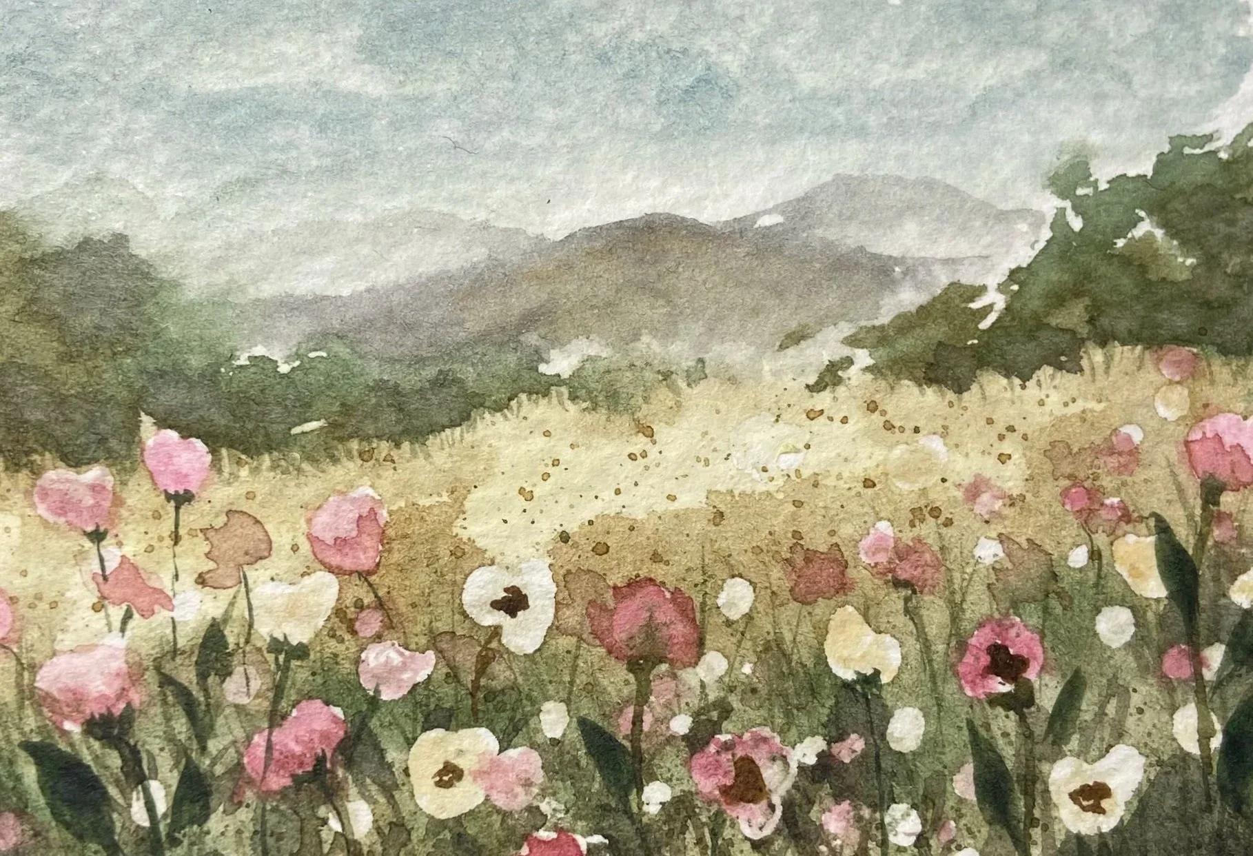 A watercolor painting of a landscape with pink flowers in the foreground, green bushes, and distant mountains under a cloudy sky.