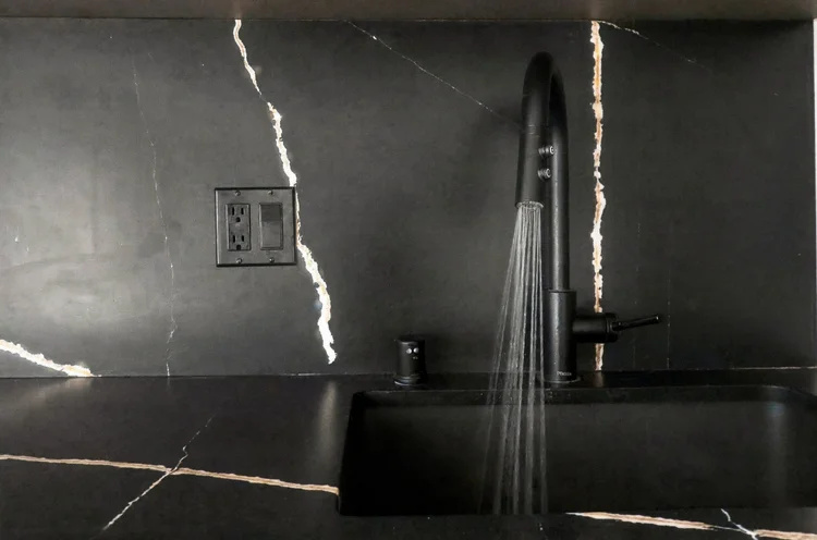 Laguna Beach loft photography: black marble kitchen detail