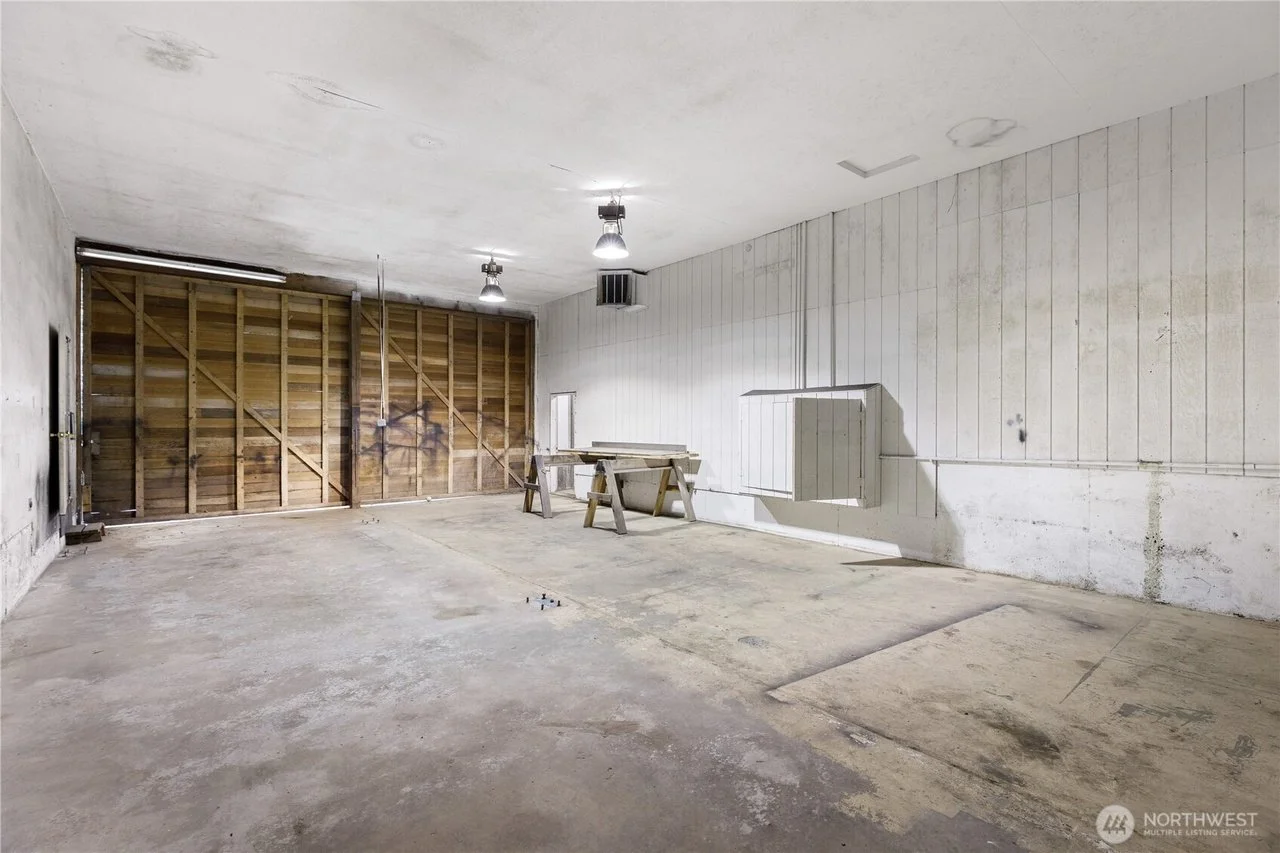 Indoor storage space with large vehicle access door