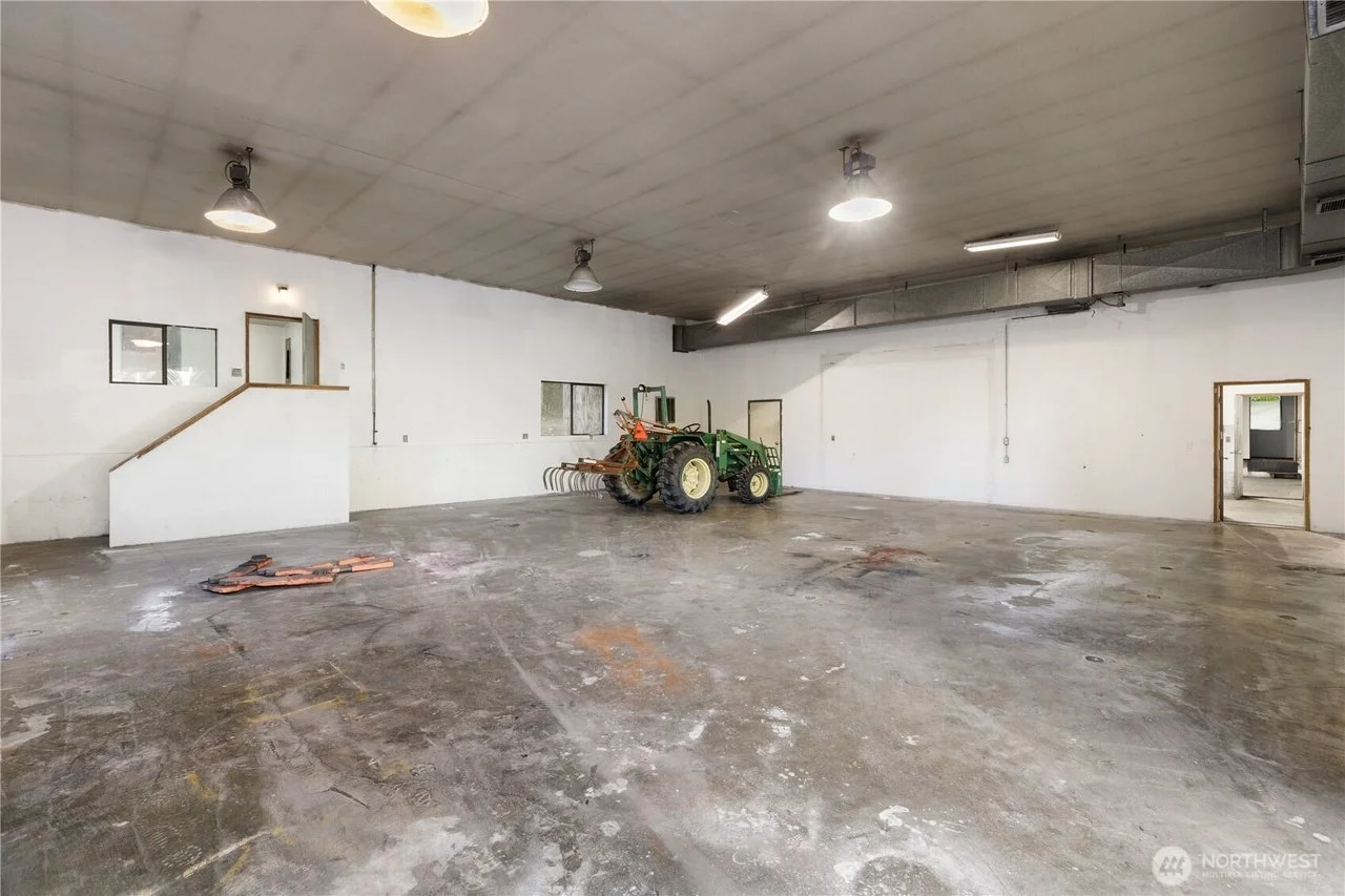 Large indoor storage bay with concrete floor and high ceiling