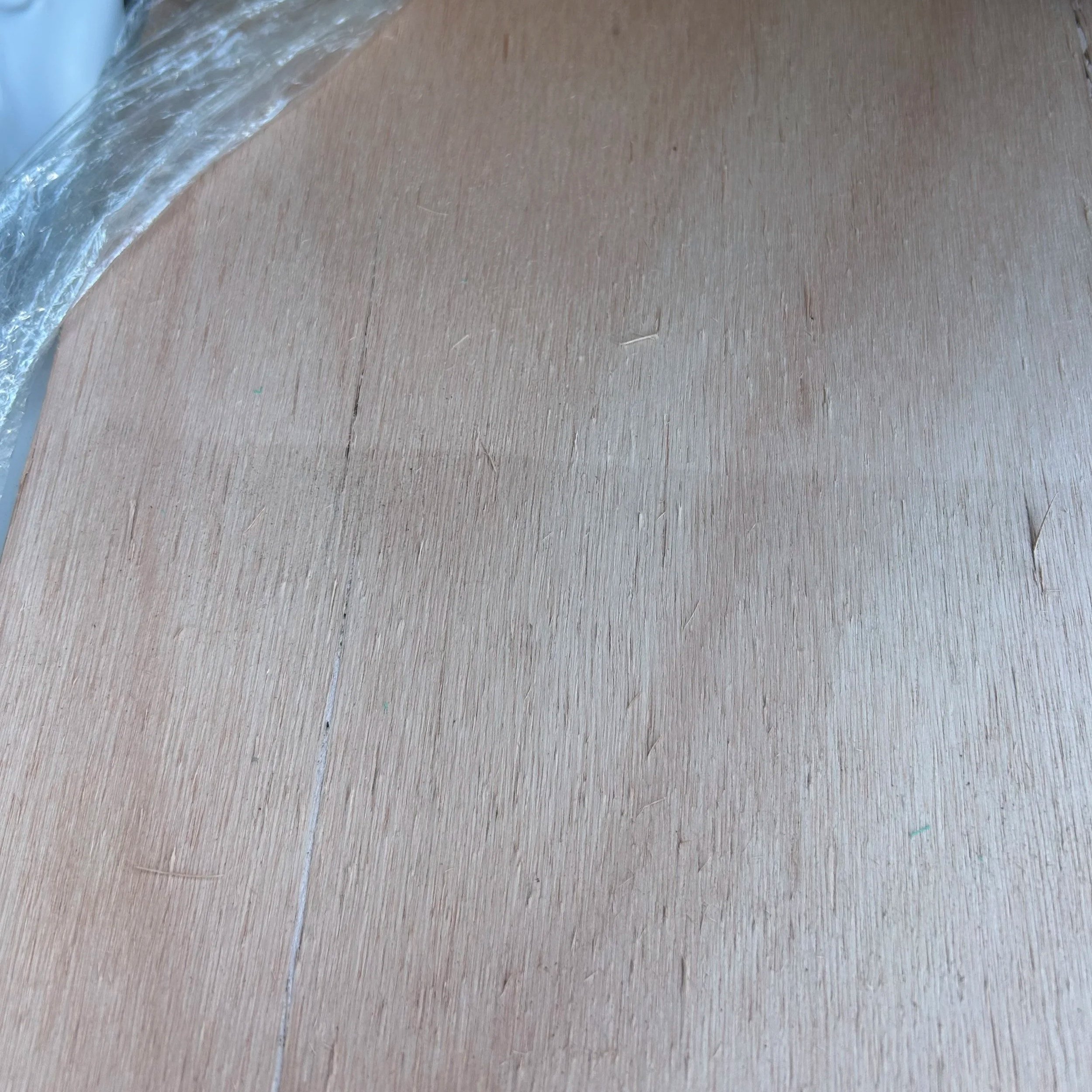 Close-up photo of a wooden surface with a small portion of water on the edge.