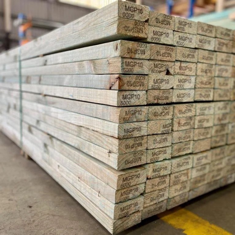 Stack of wooden planks labeled MG P10 6000 in a warehouse