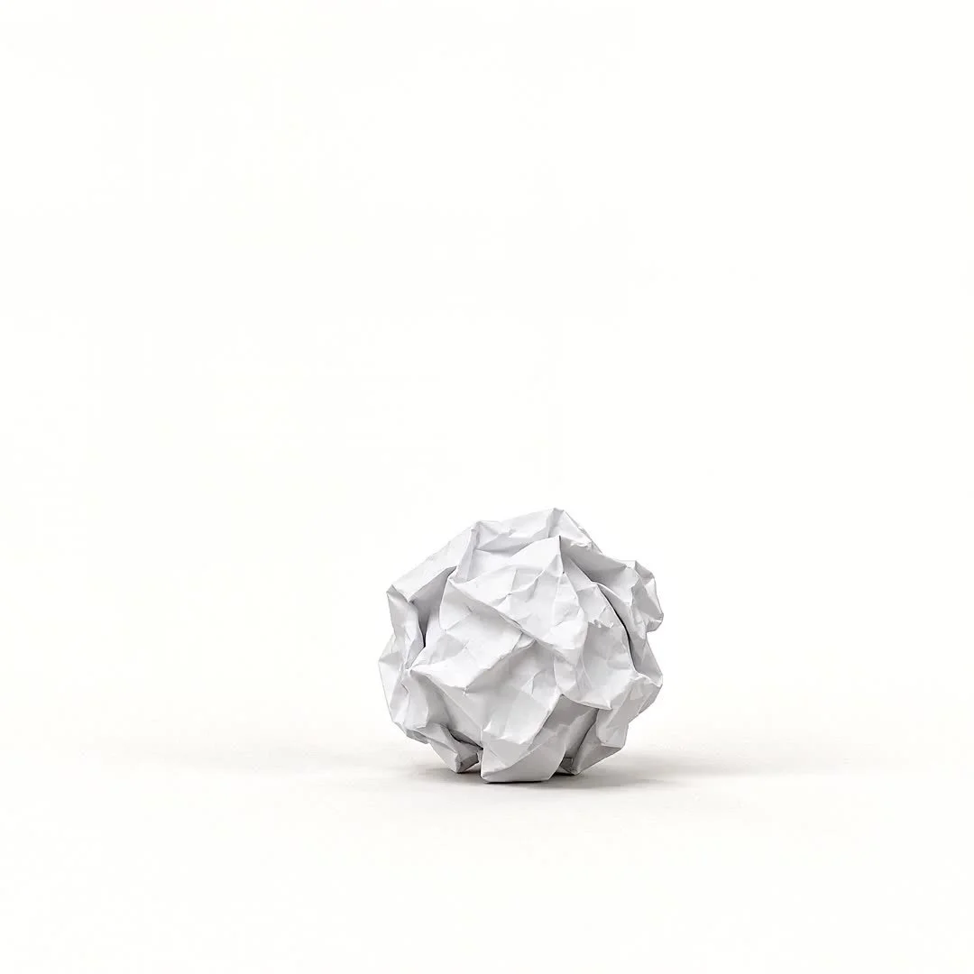 A paper ball, ready to unfold into an origami crane.