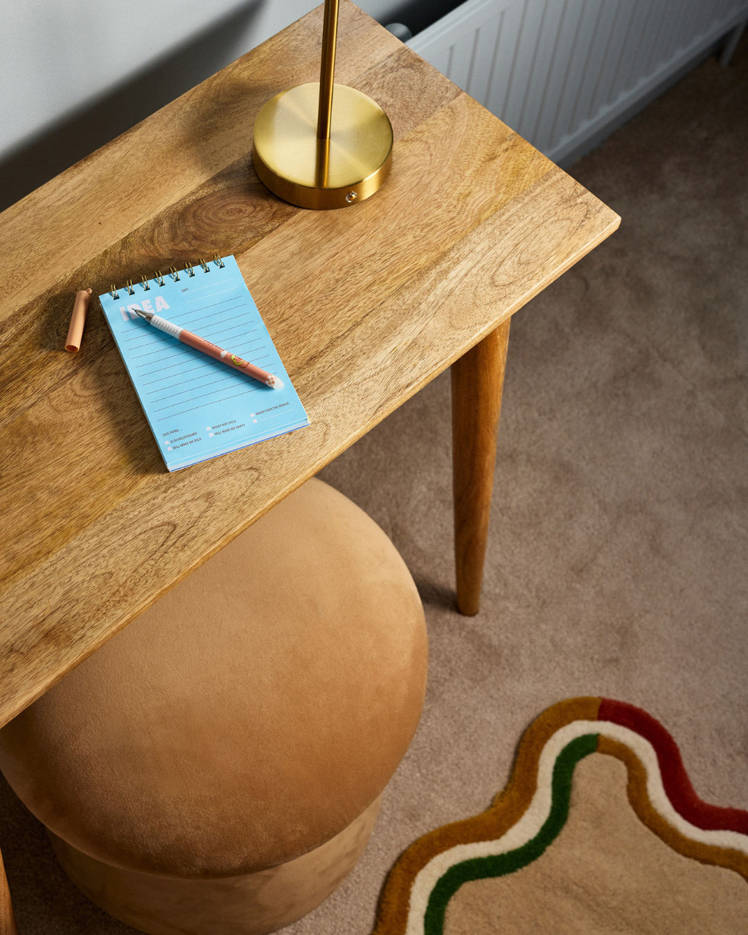 children room in light blue muted tones. with burgundy accents and wave patterns. top angle shot desk