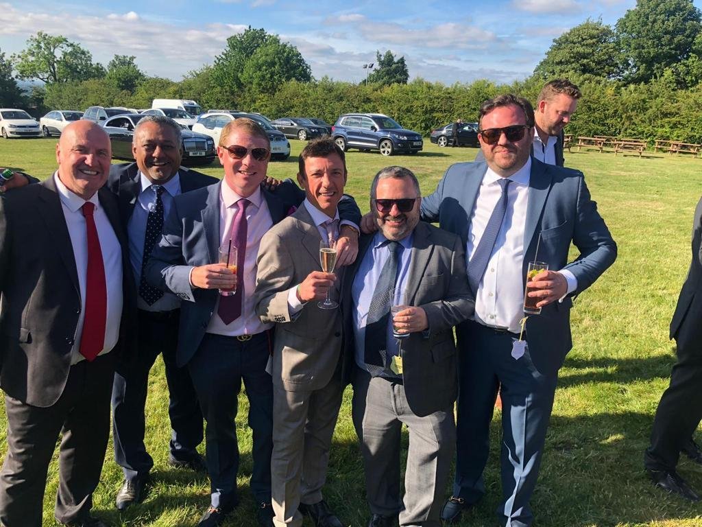 Ivor and legendary jockey Frankie Dettori share some bubbly at the races