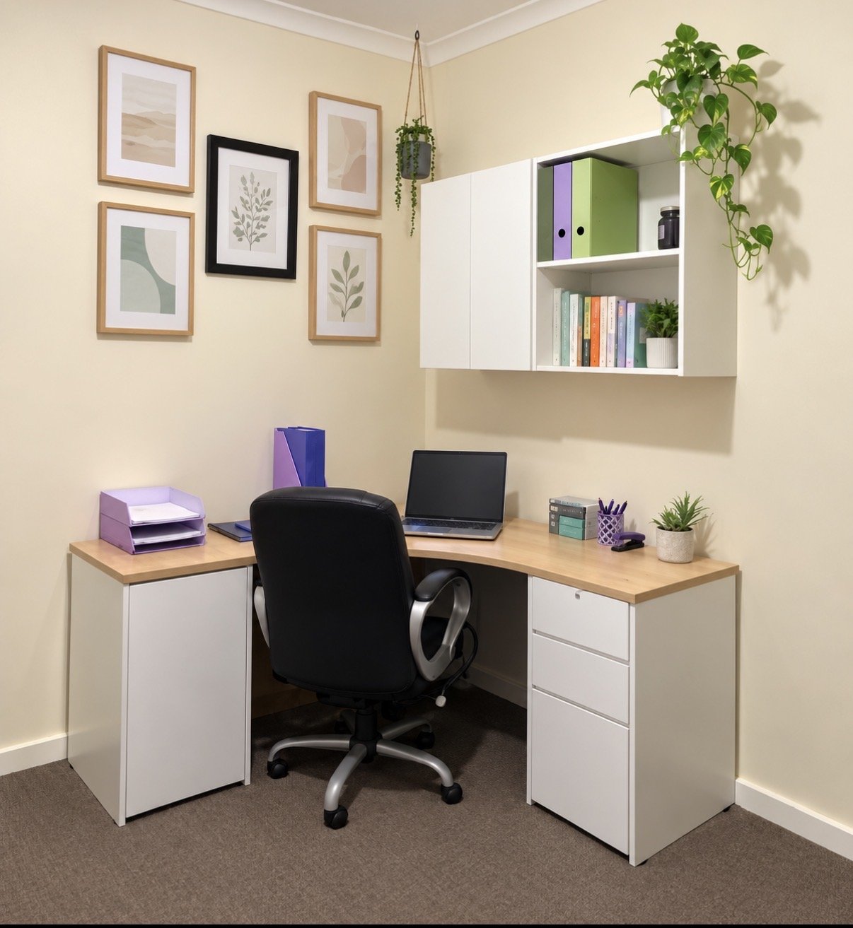 Home office with a corner desk, black swivel chair, wall shelves with books and plants, framed artwork, and office supplies.