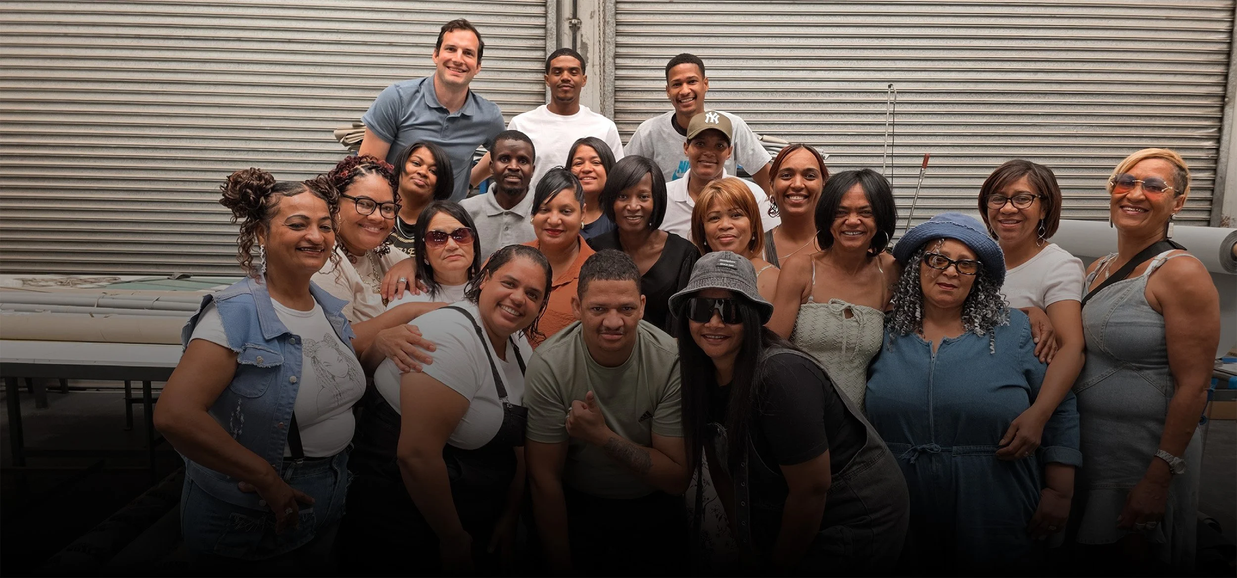 The Stitch SA manufacturing team group photo in a factory.