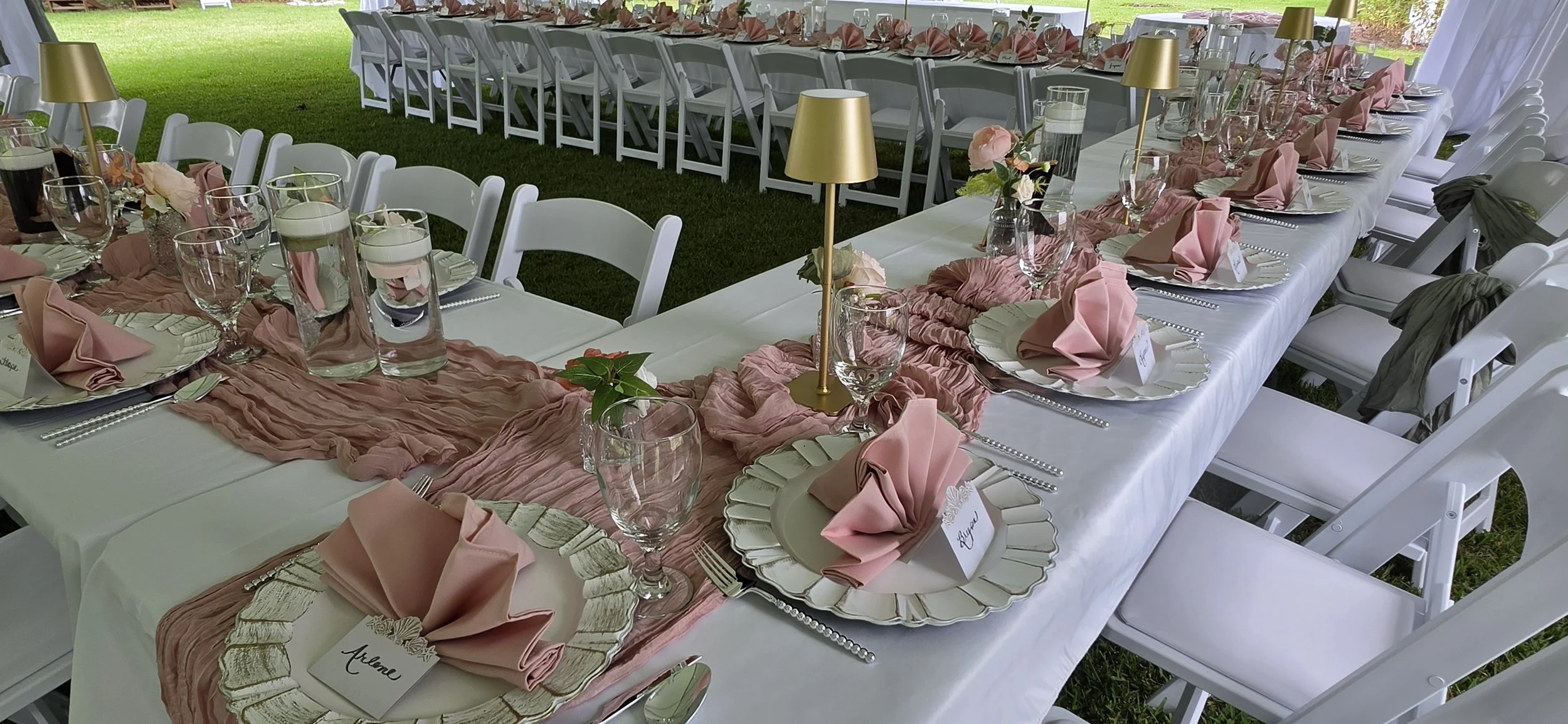 Wedding reception table with blush linens, floral centerpieces, and candle accents at Bostwick’s Magnolia Manor.