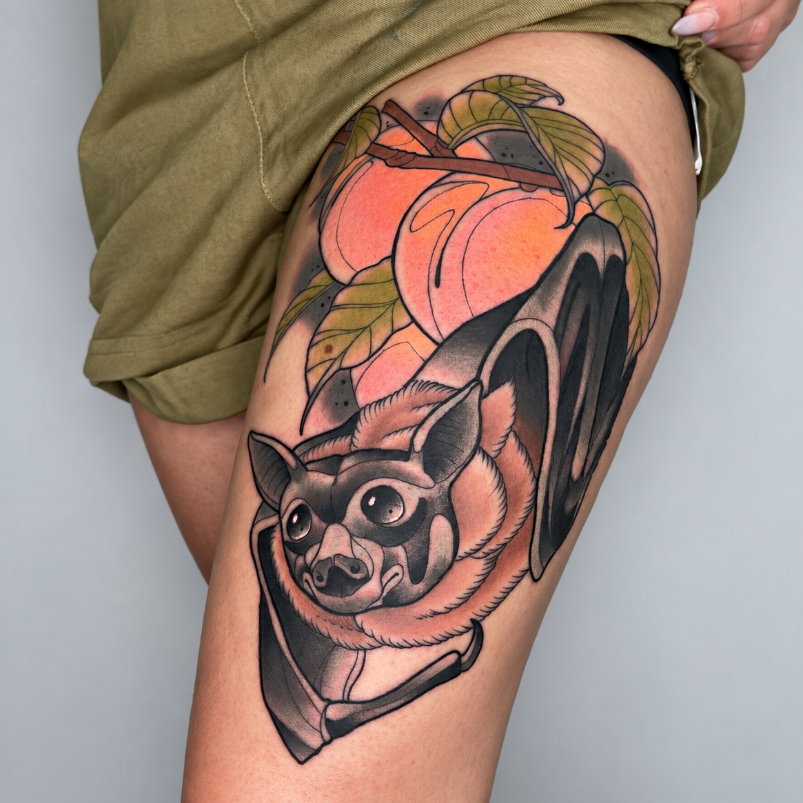 Color neo-traditional bat tattoo with peach and leaves by Miami tattoo artist Adrian Aguirre